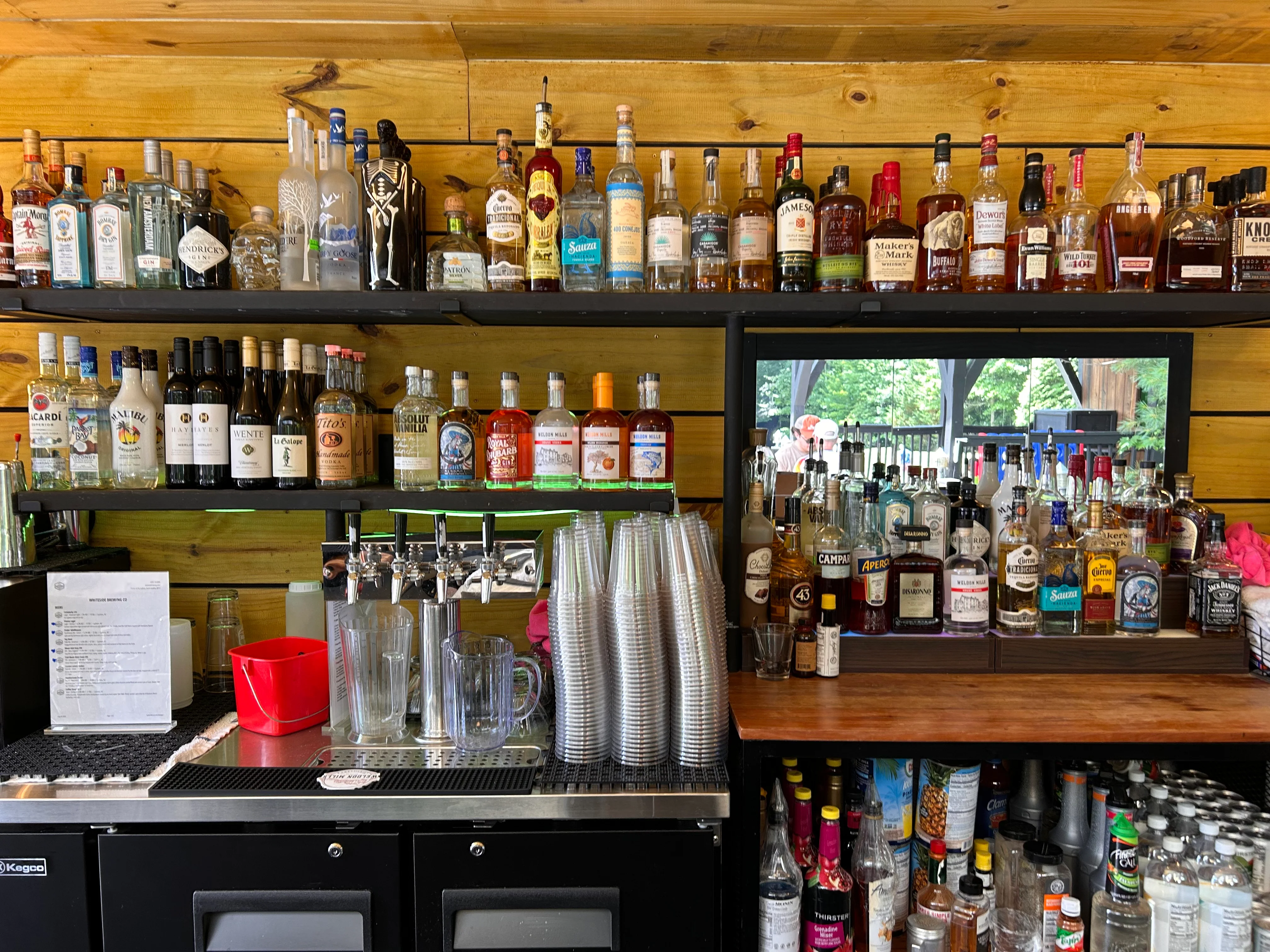 Well-stocked bar with various spirits and cocktails
