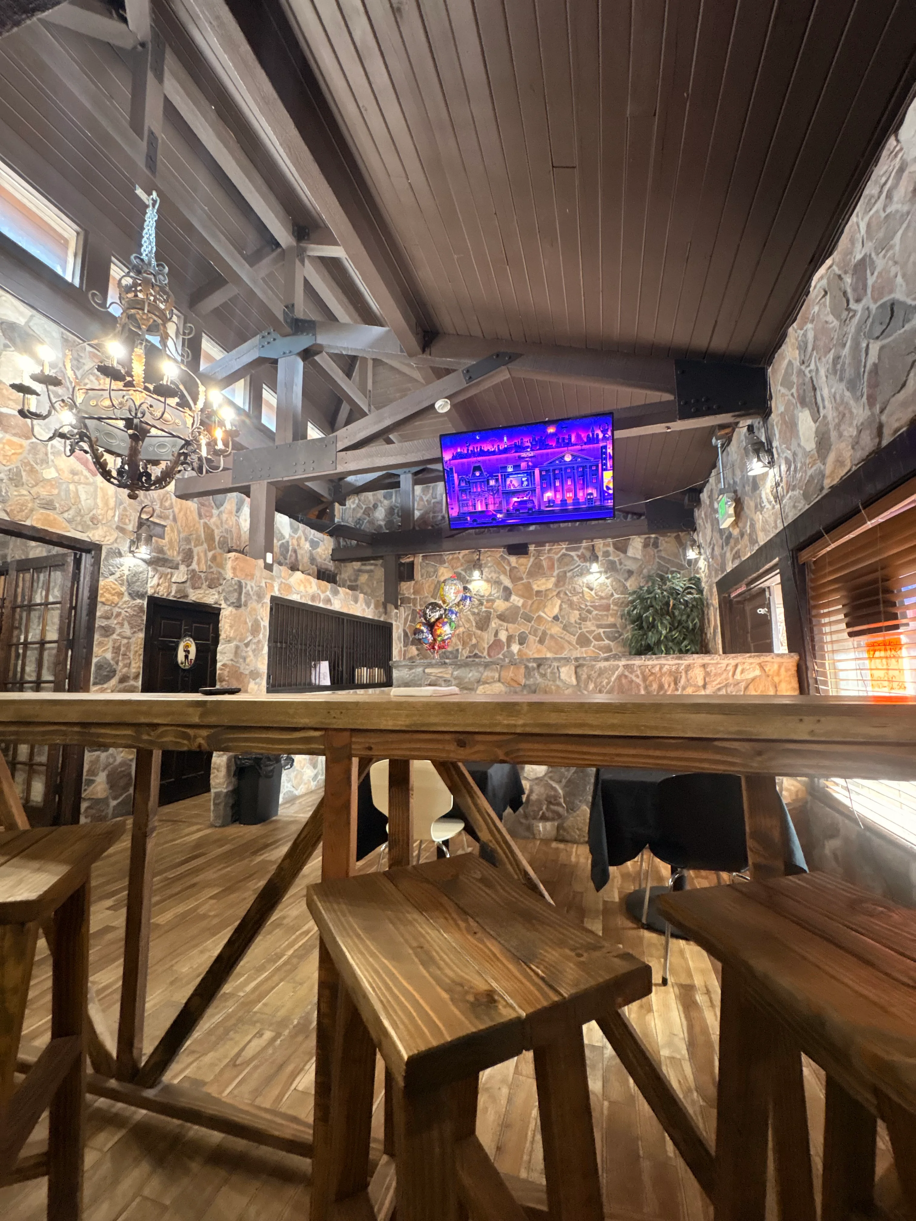 Cozy restaurant interior with wooden decor and stone walls
