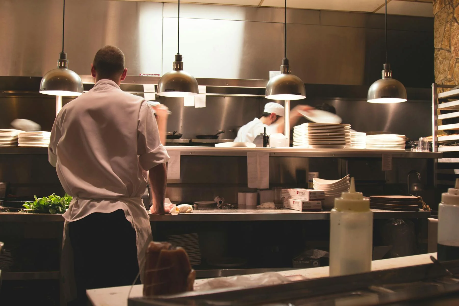 Busy restaurant kitchen with chefs preparing dishes