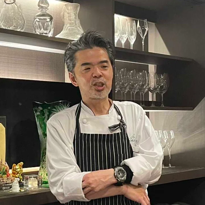 Chef in a modern kitchen setting with elegant glassware
