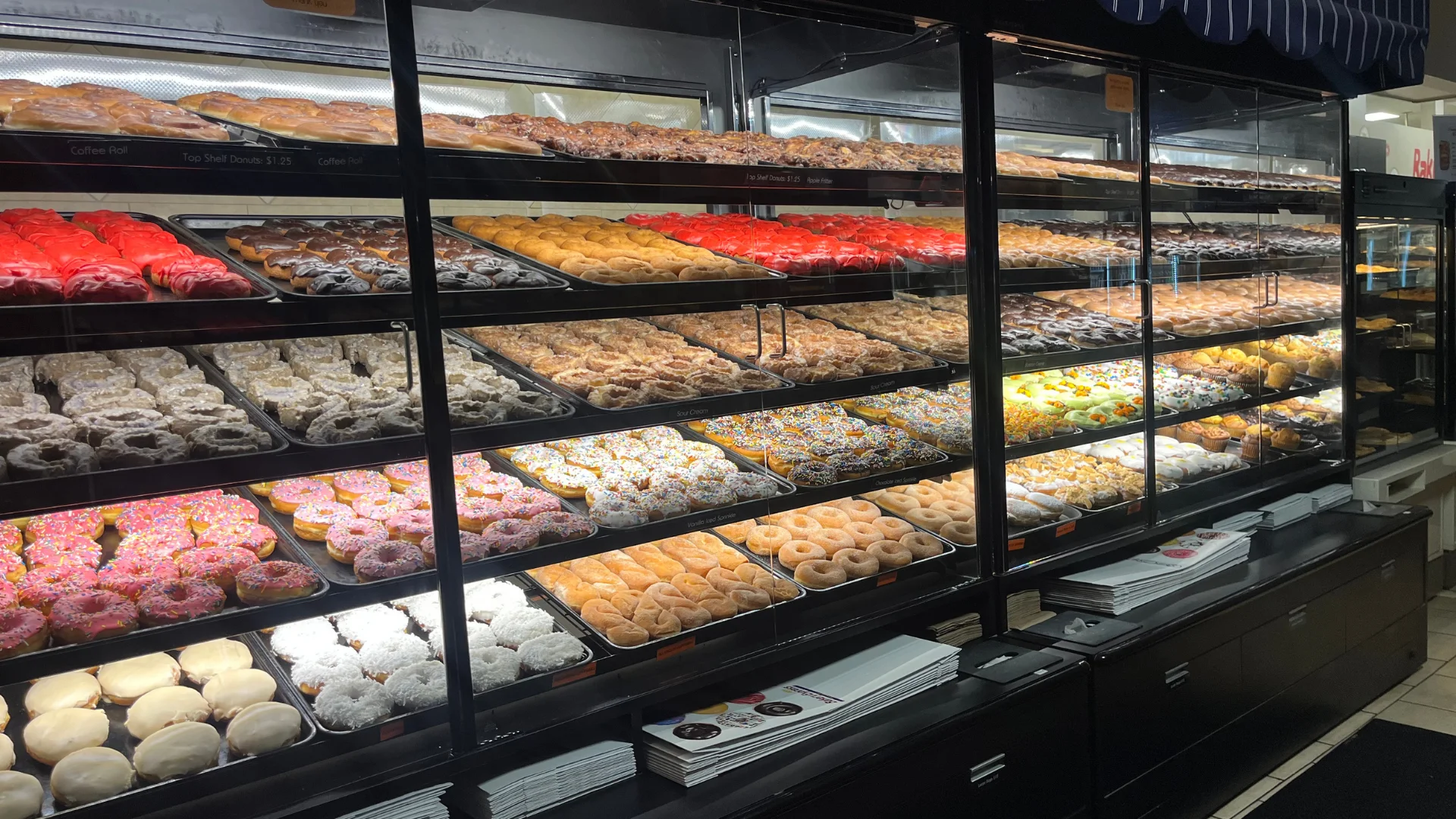 Assorted gourmet cakes and cupcakes in a display case