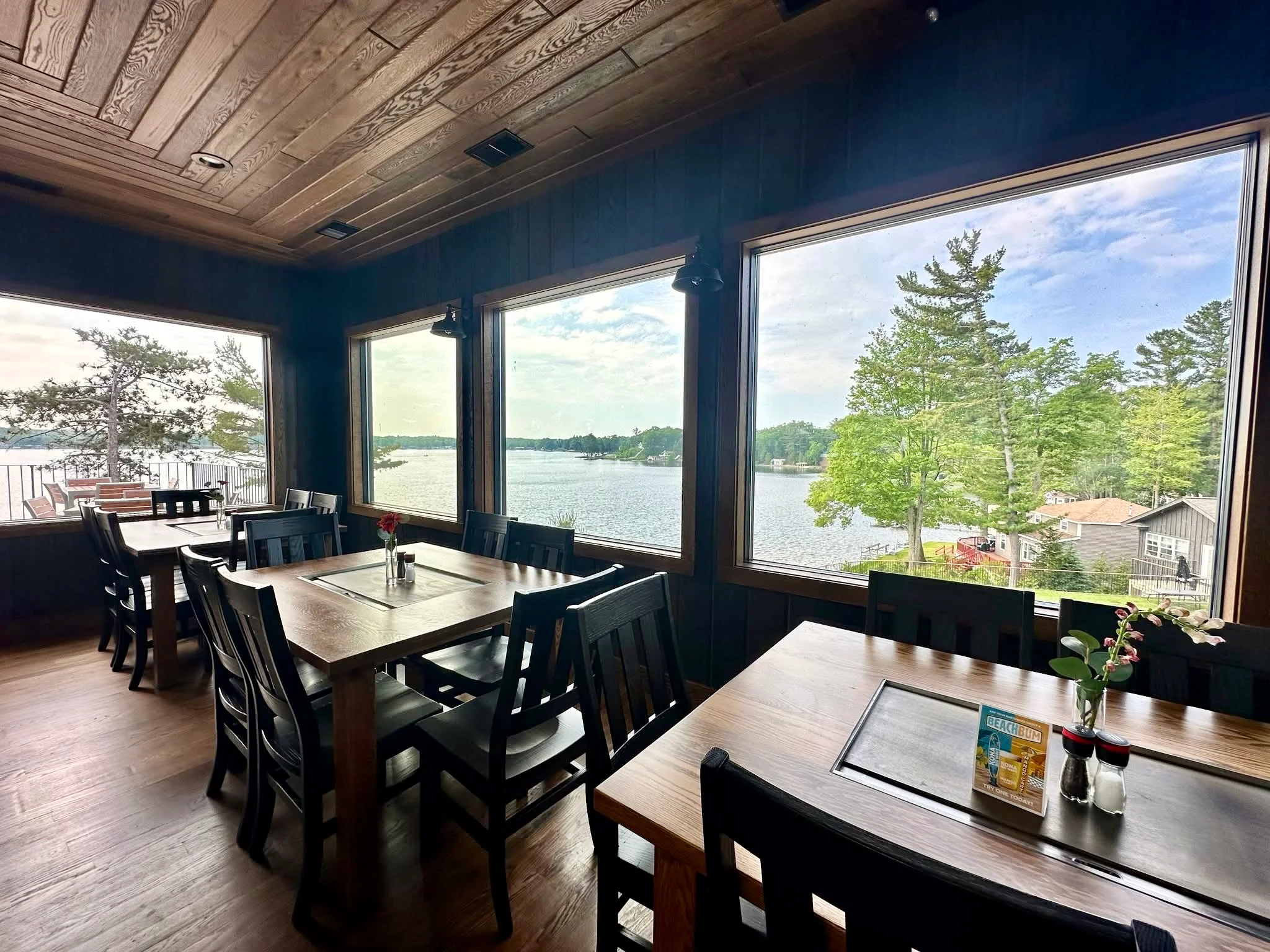 Cozy restaurant interior with lake view and wooden decor