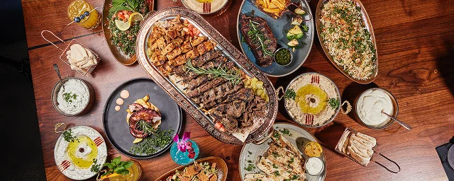 Delicious shawarma platter with fresh vegetables and sauces