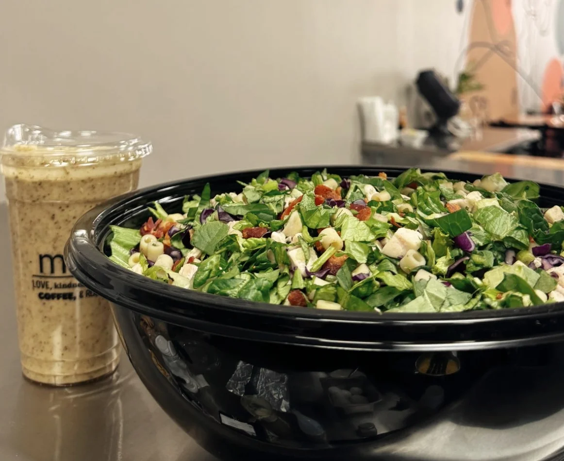 Vibrant salad bowl with fresh greens and toppings in a modern cafe setting