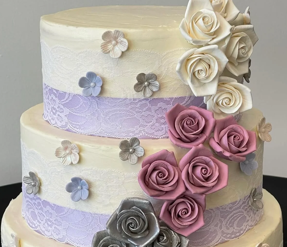 Elegant three-tier wedding cake with floral decorations
