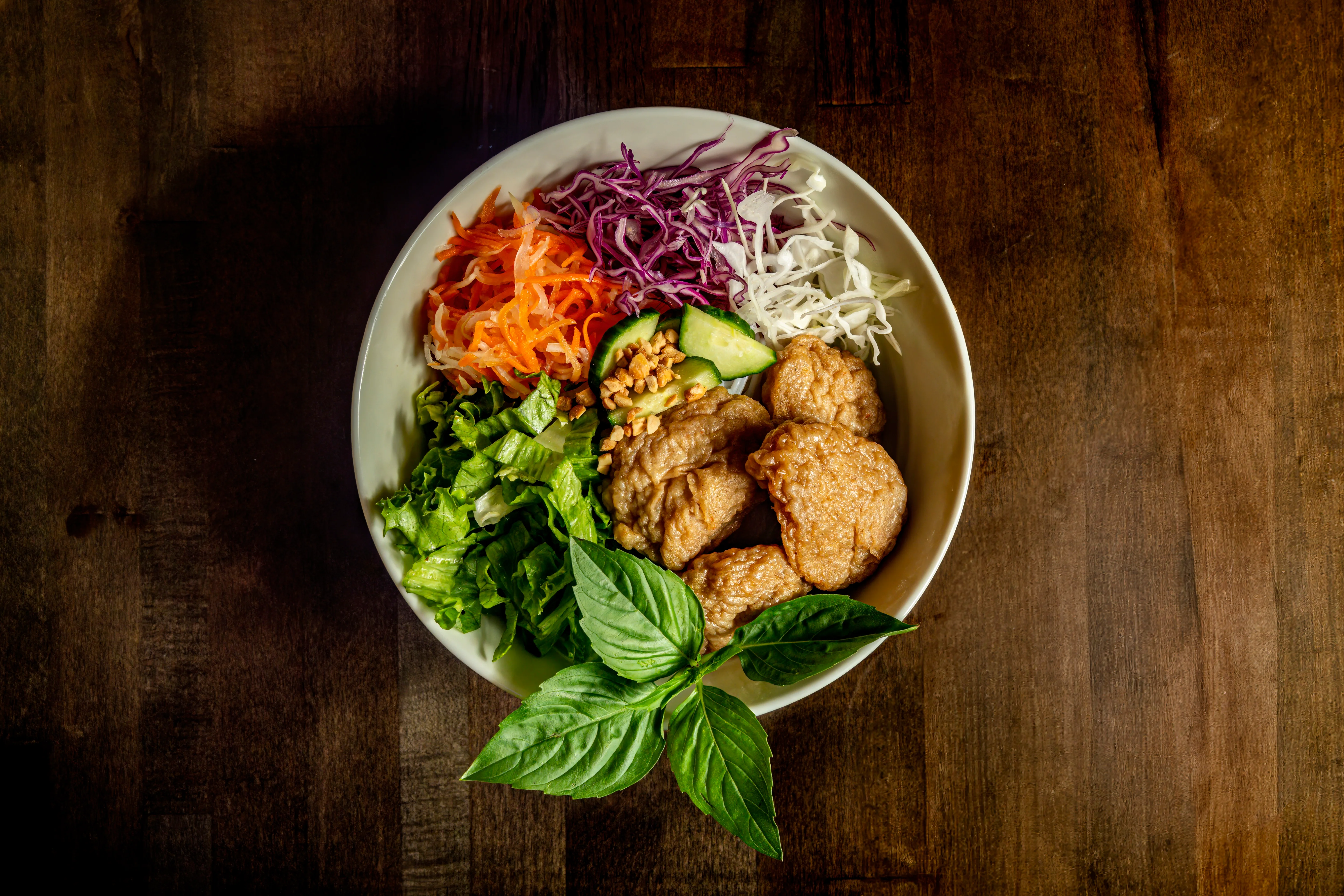 Vietnamese rice bowl with crispy chicken and fresh vegetables