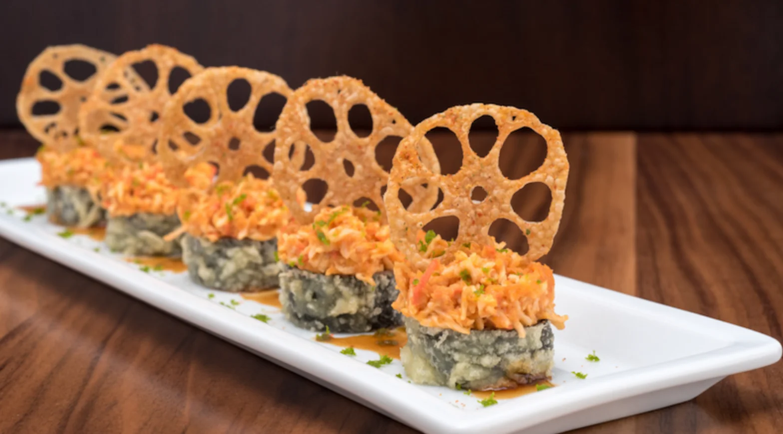 Crispy Japanese sushi rolls with lotus root garnish
