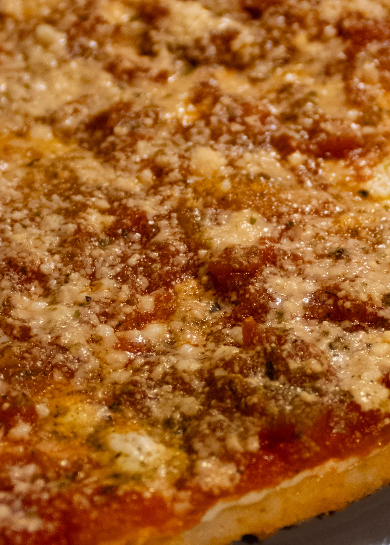 Slice of classic Italian pizza with tomato sauce and cheese
