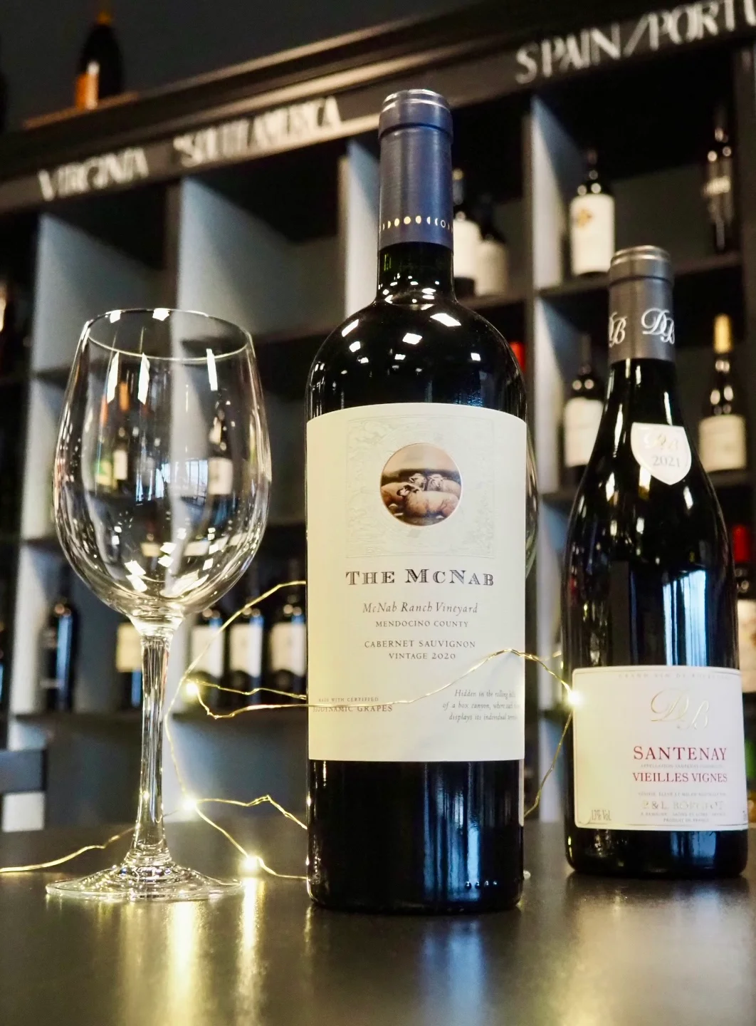 A collection of wine glasses hanging upside down from a bar rack, showcasing their intricate design and clarity.