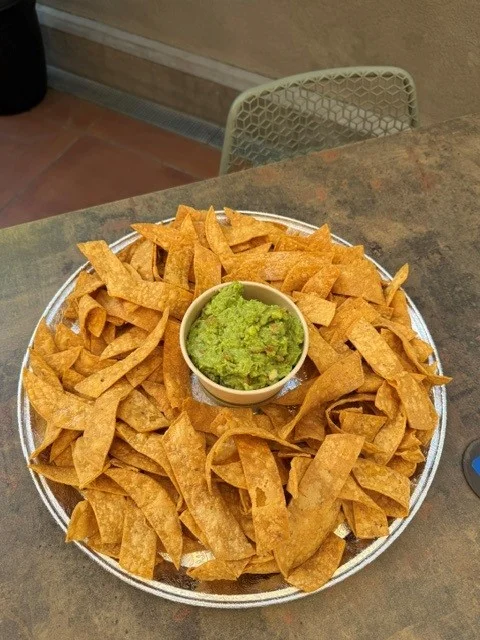Bowl of guacamole served with crispy tortilla chips