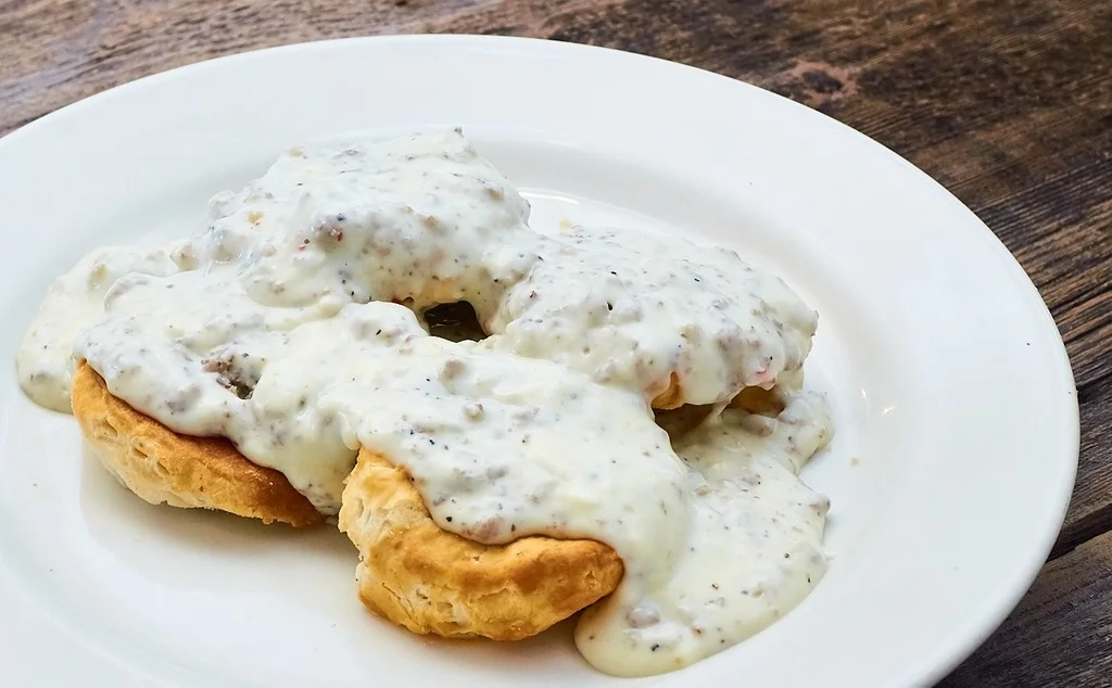 Southern biscuits and gravy served on a white plate