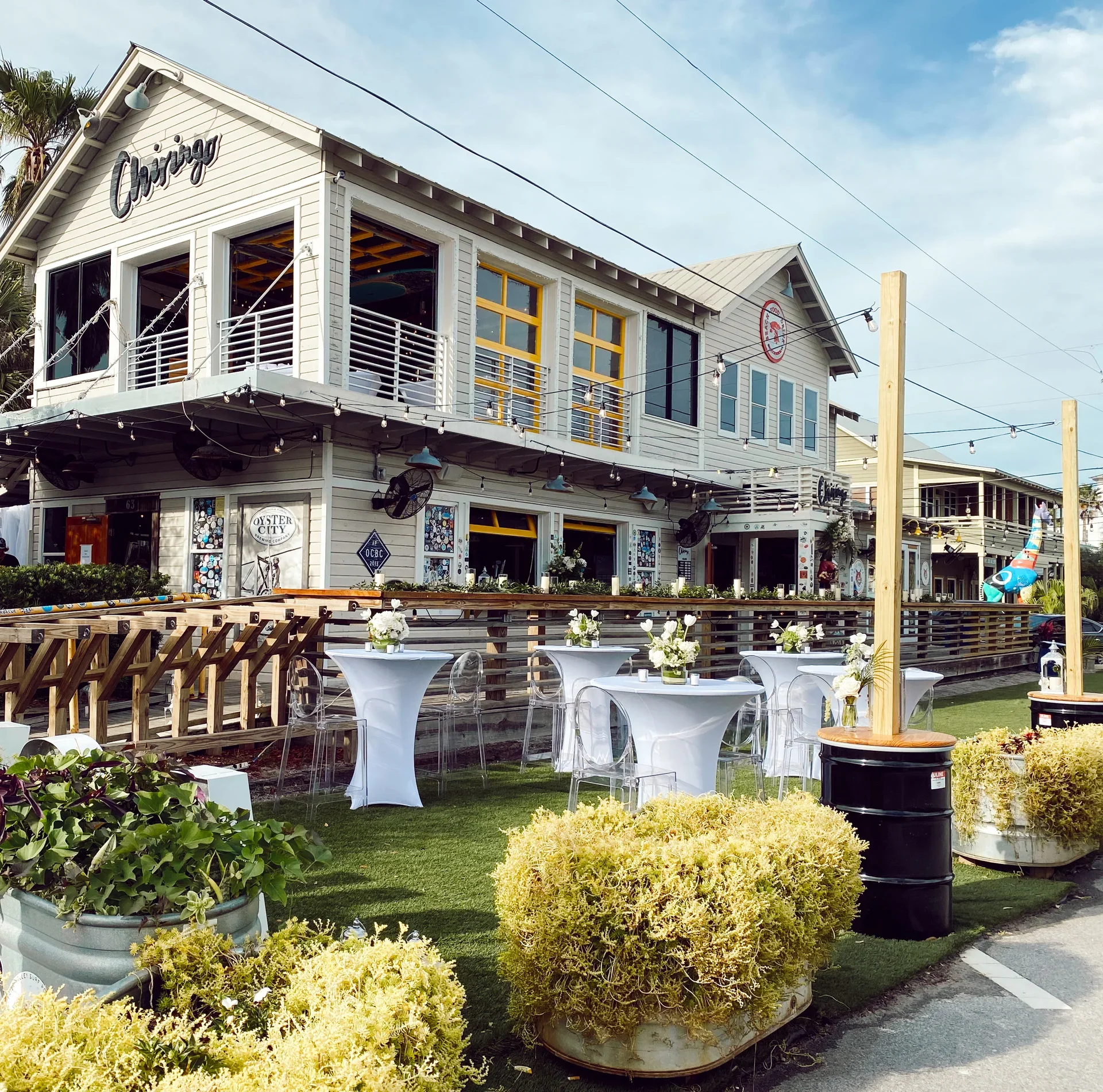 Charming restaurant exterior with outdoor seating and floral decor