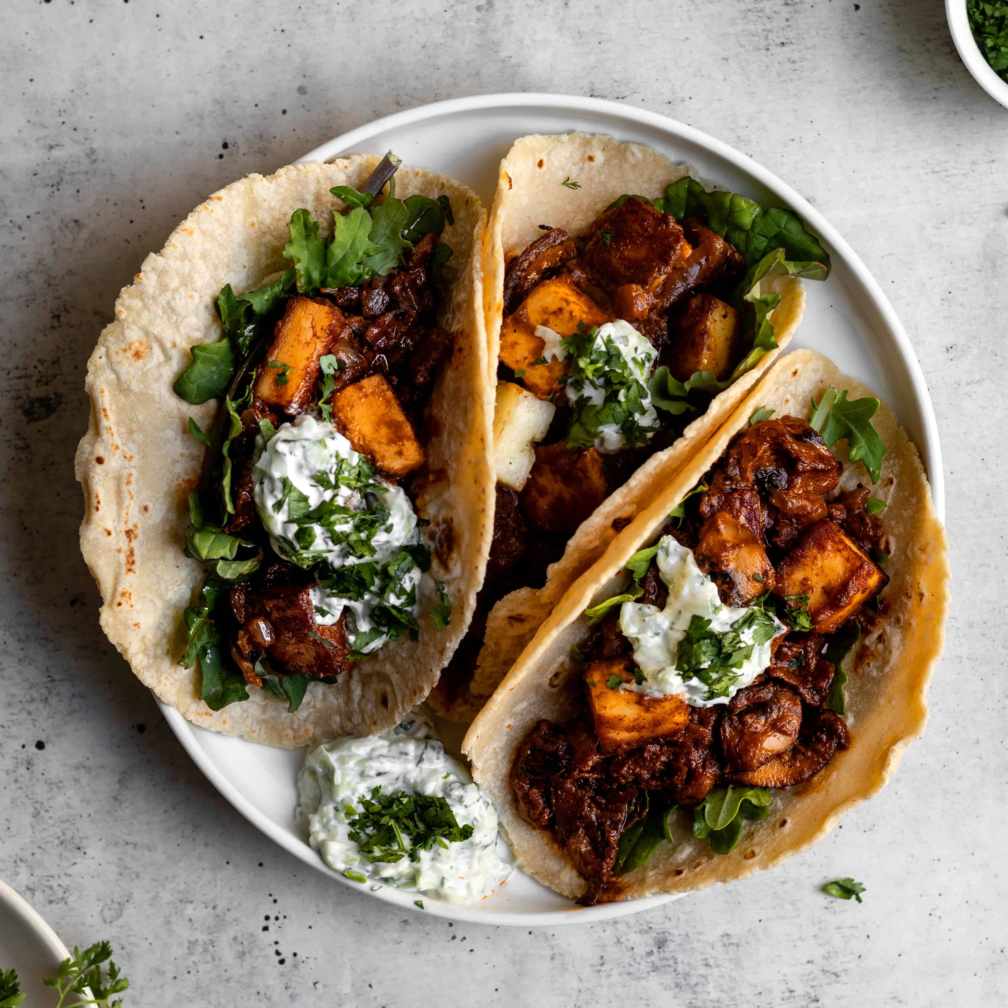 Delicious Indian-style tacos with spiced meat and yogurt sauce