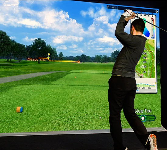 Person swinging a golf club in a virtual golf simulation environment.