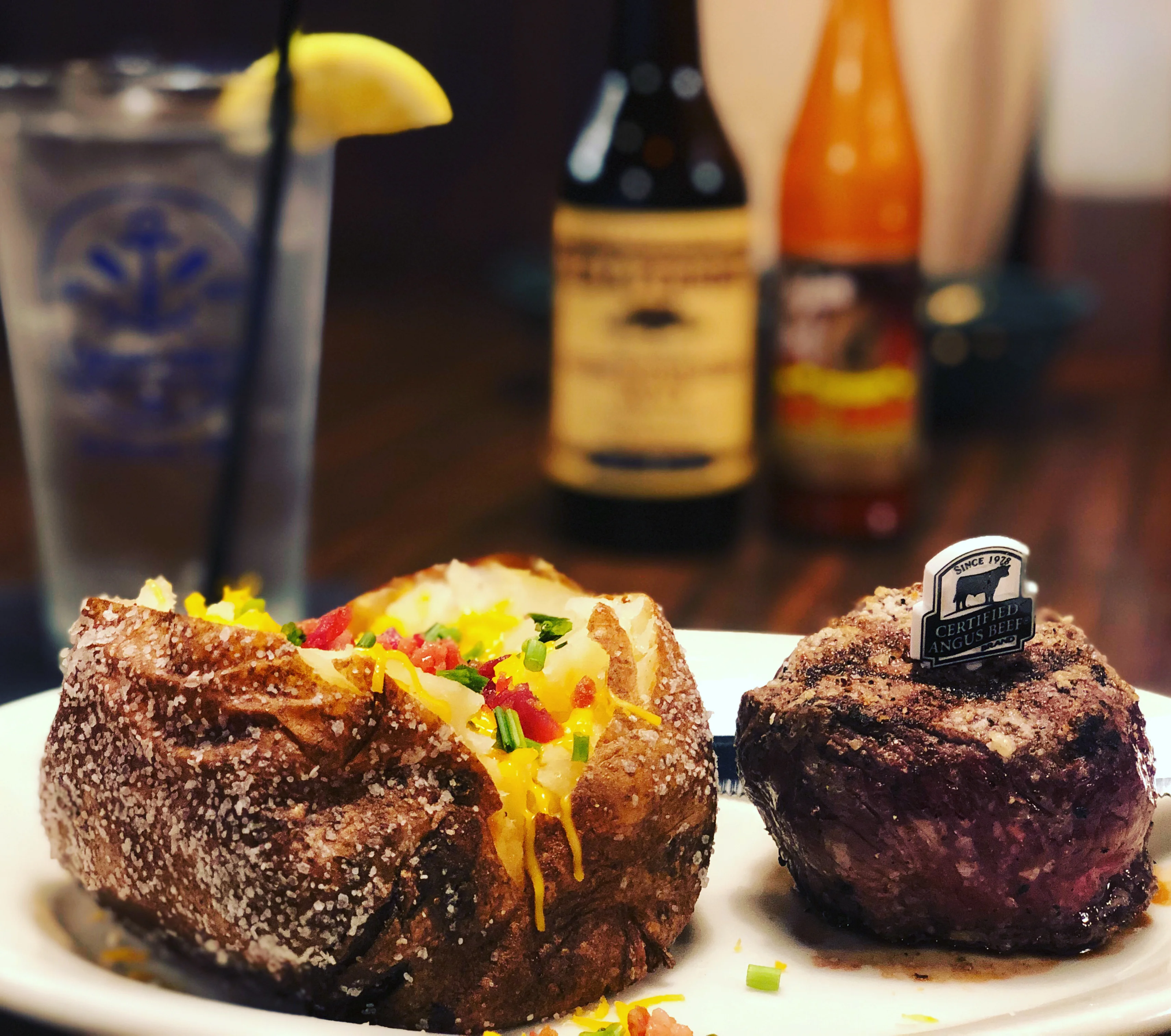 Baked potato with toppings and Certified Angus Beef steak