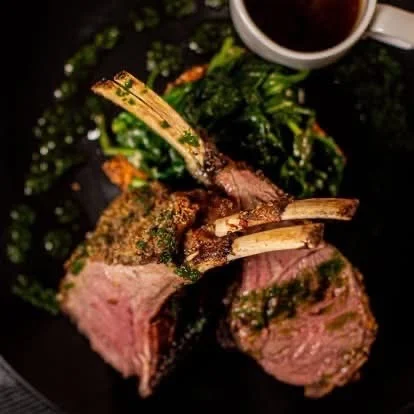 Herb-crusted rack of lamb with greens and sauce