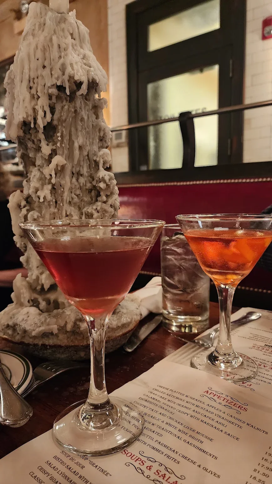 Elegant cocktails on a rustic table in a cozy restaurant setting