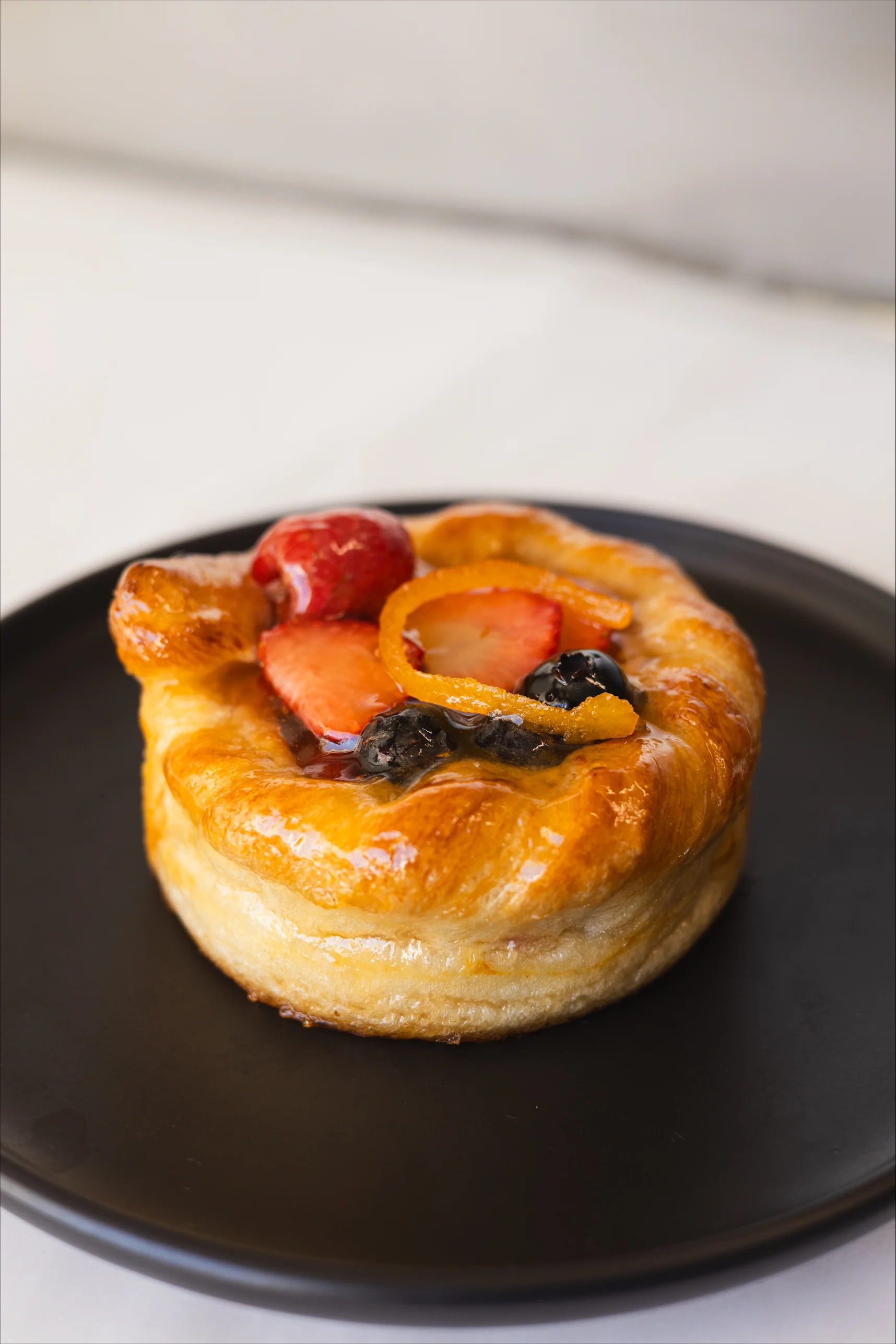Fruit tart pastry with berries and citrus glaze