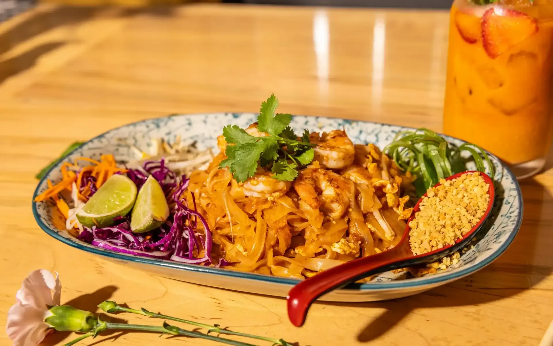 Plate of Thai pad thai with shrimp and fresh lime