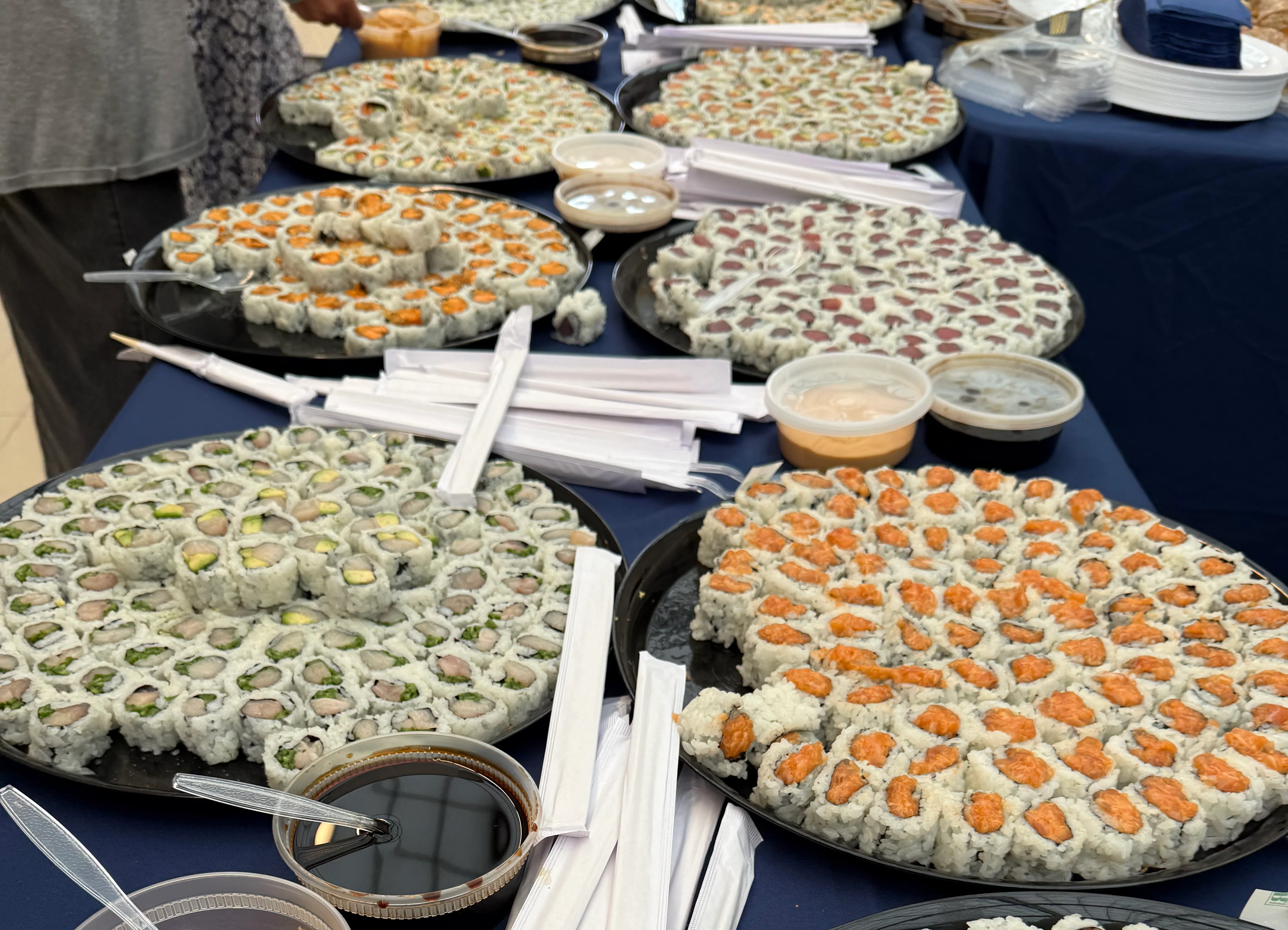Artfully arranged sushi platter with avocado and decorative garnishes