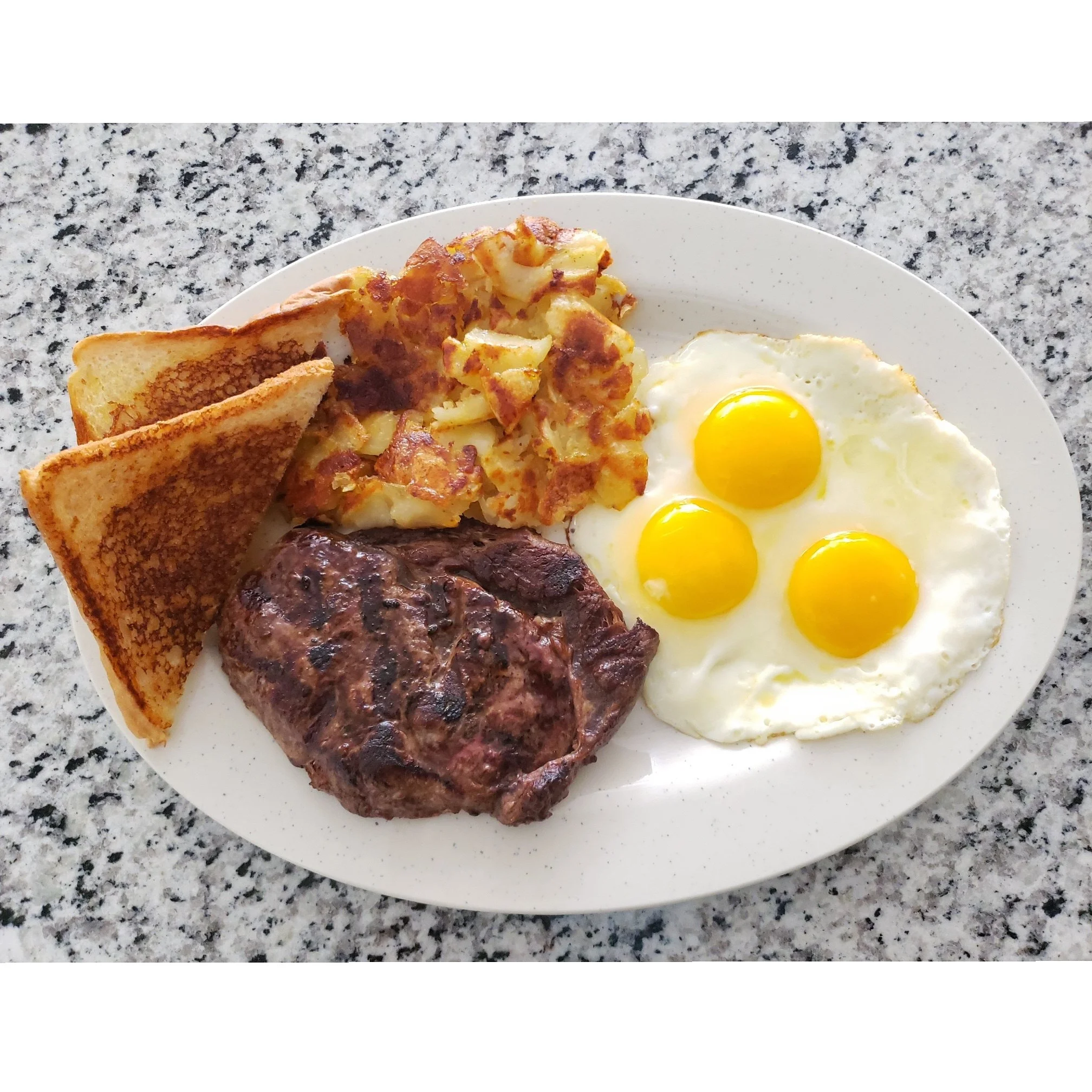 Classic American breakfast with steak and eggs