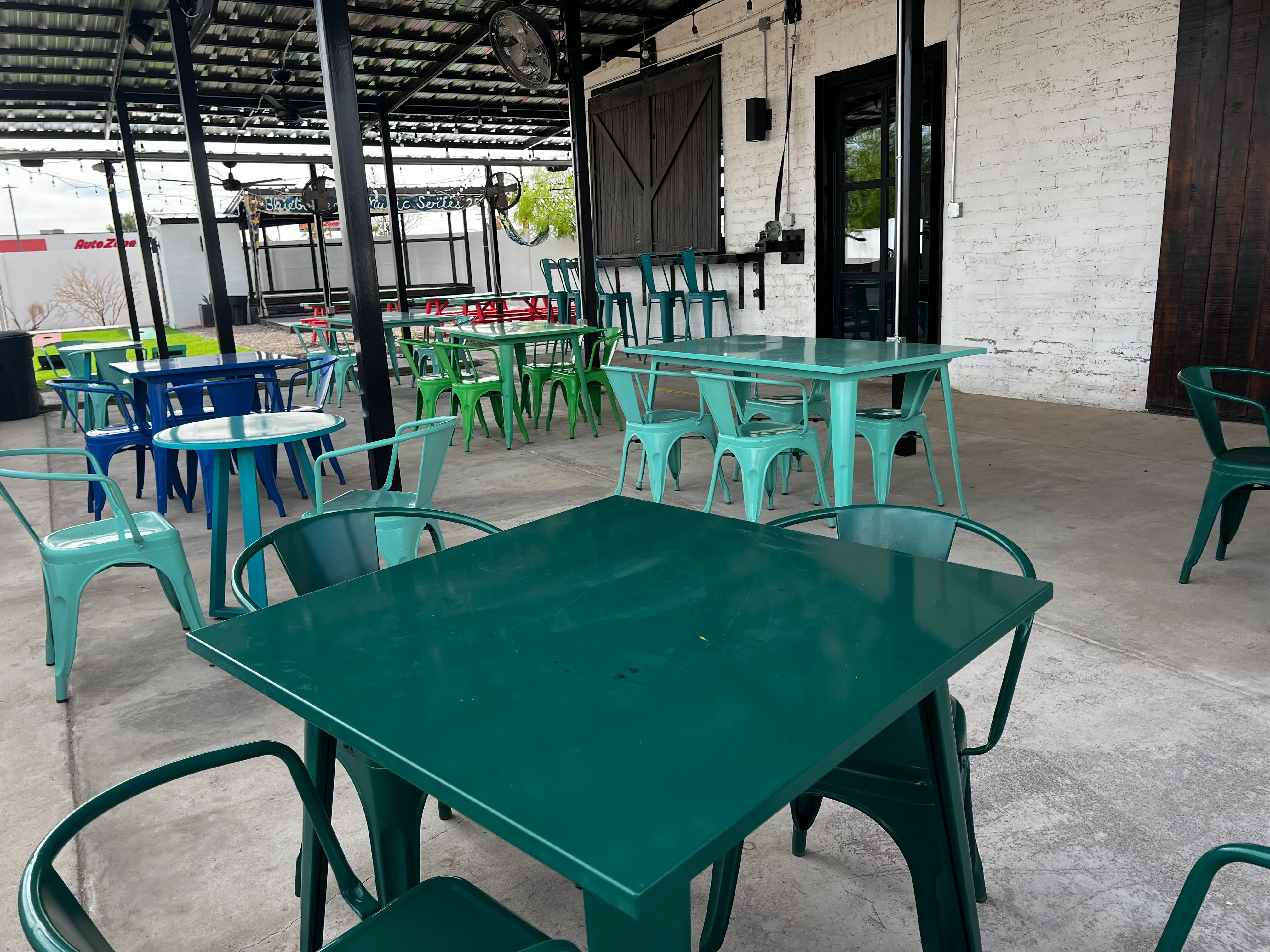 Outdoor dining area with colorful tables and chairs