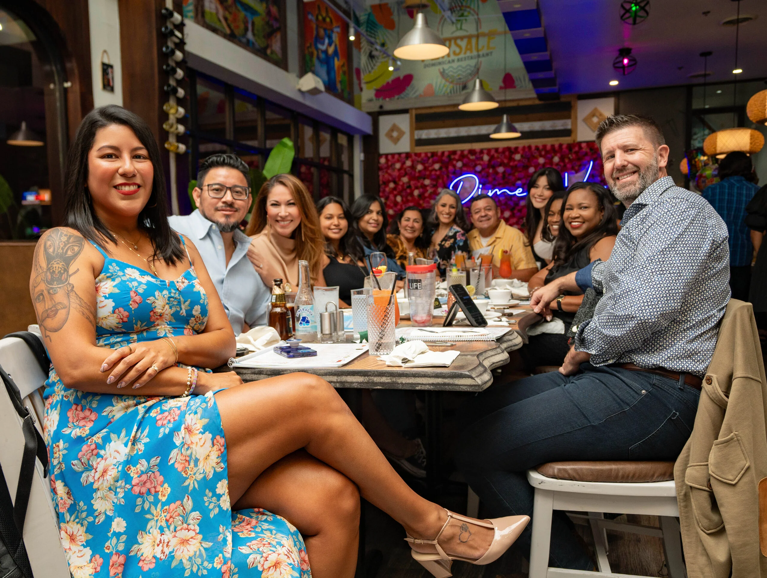 Group of friends enjoying dinner at a vibrant restaurant