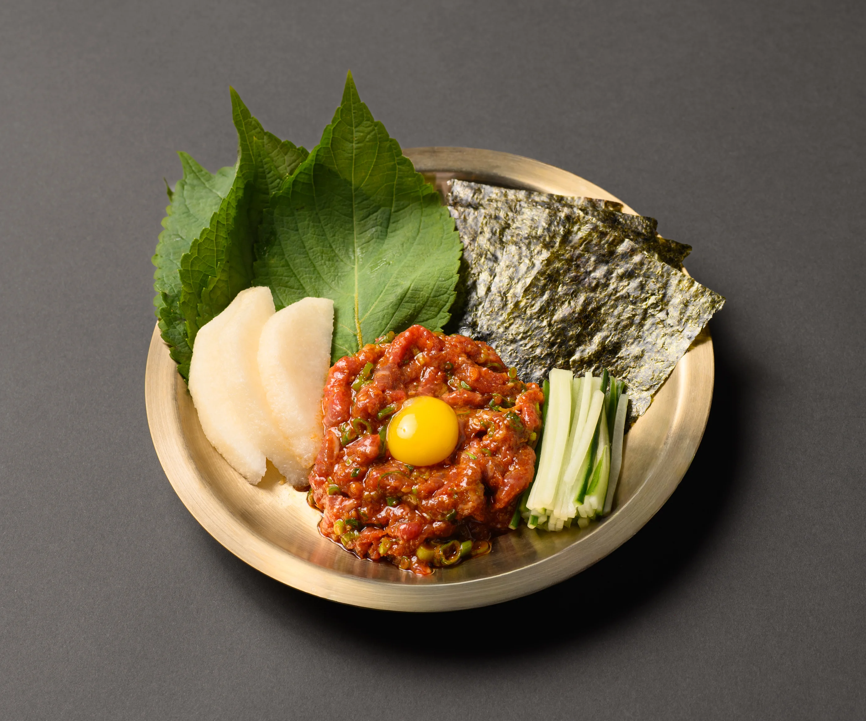 Korean yukhoe served with fresh vegetables and egg yolk