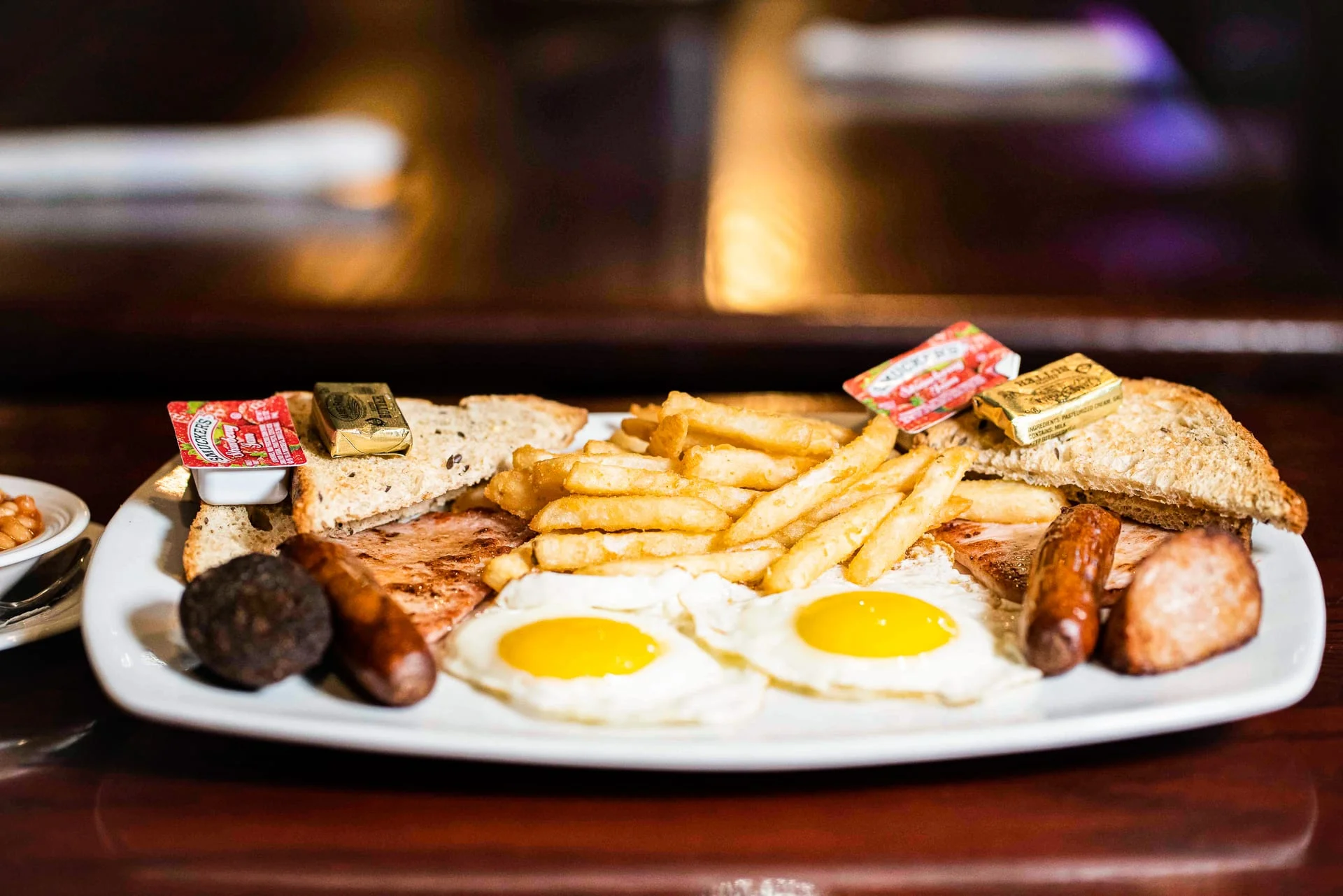 Traditional English breakfast with eggs, sausage, and toast