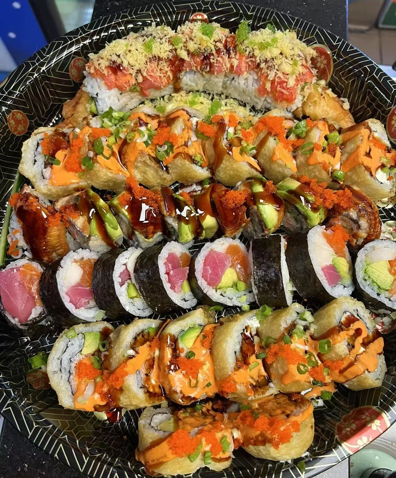 Assorted sushi platter featuring various rolls and toppings