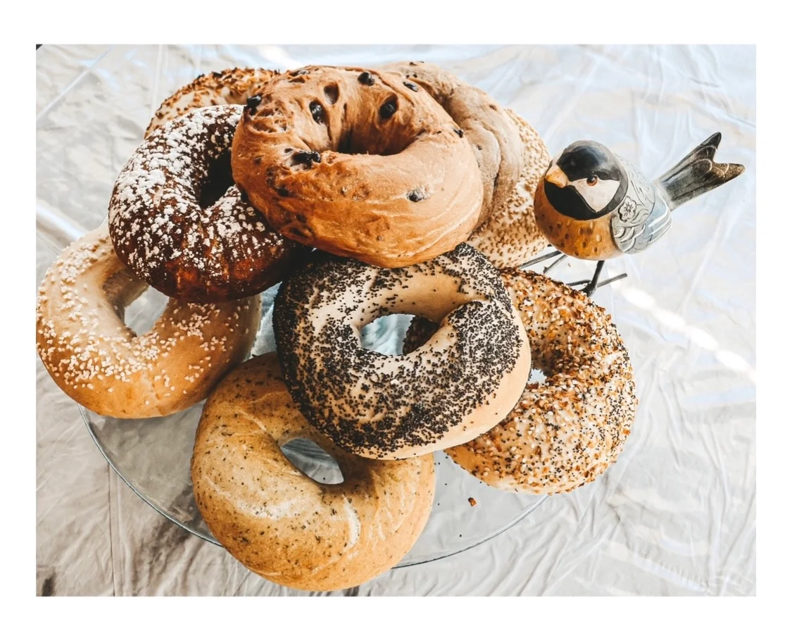 Assorted bagels on a glass platter
