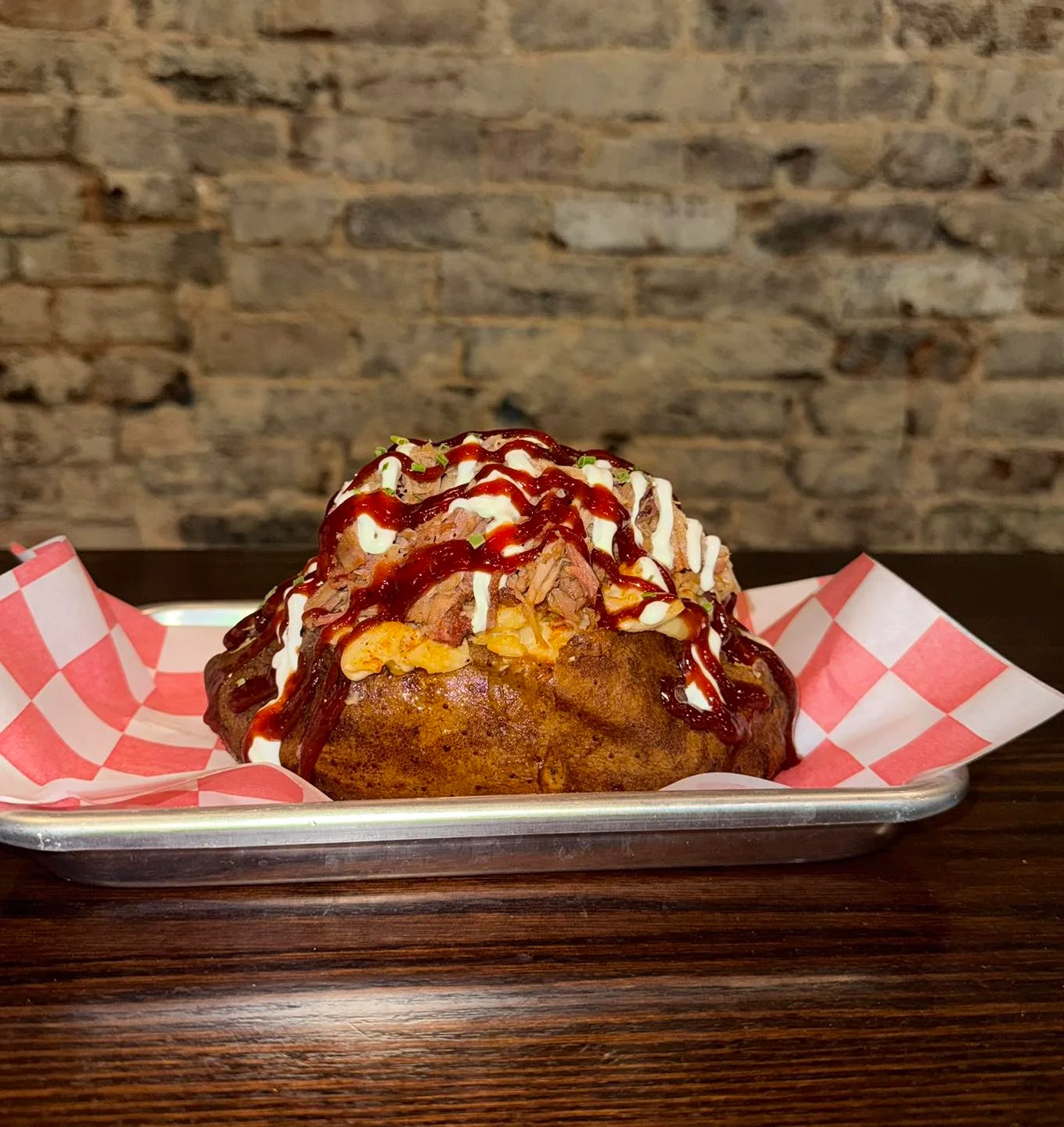 Loaded baked potato with pulled pork and barbecue sauce