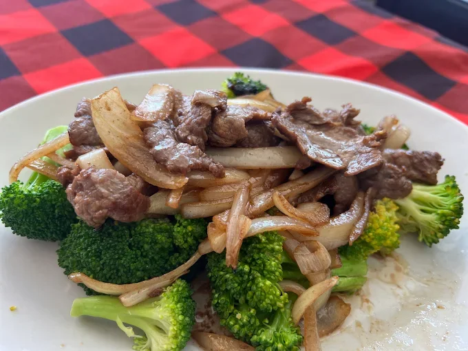 Beef and broccoli stir-fry on a white plate