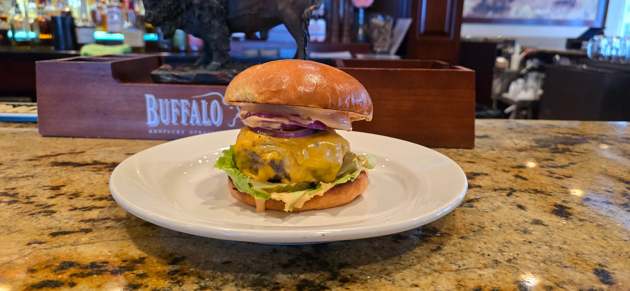 Juicy cheeseburger on a toasted bun in a restaurant setting