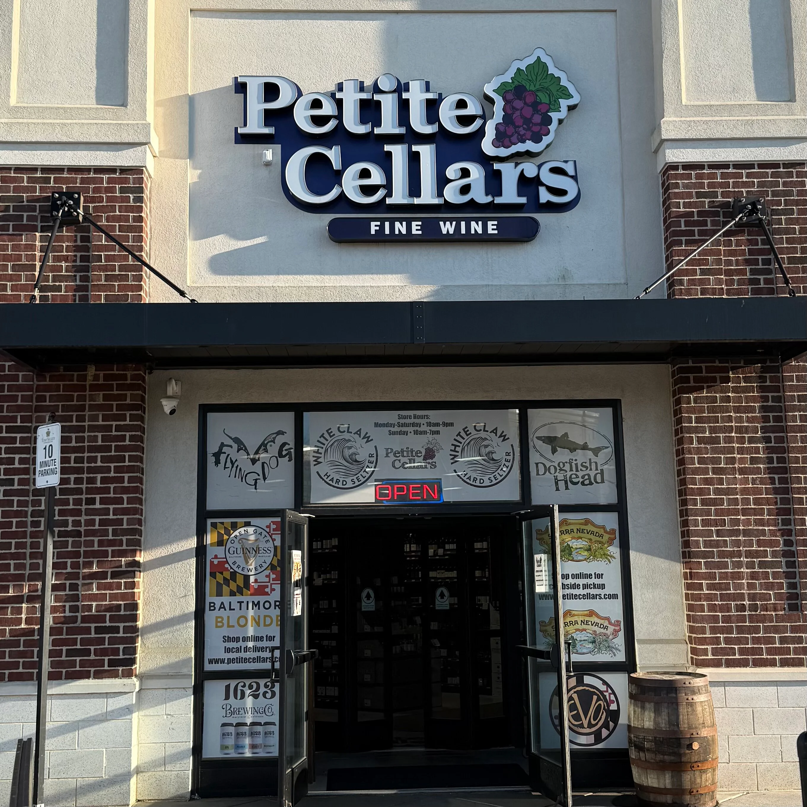 Entrance of Petite Cellars Fine Wine store with open sign