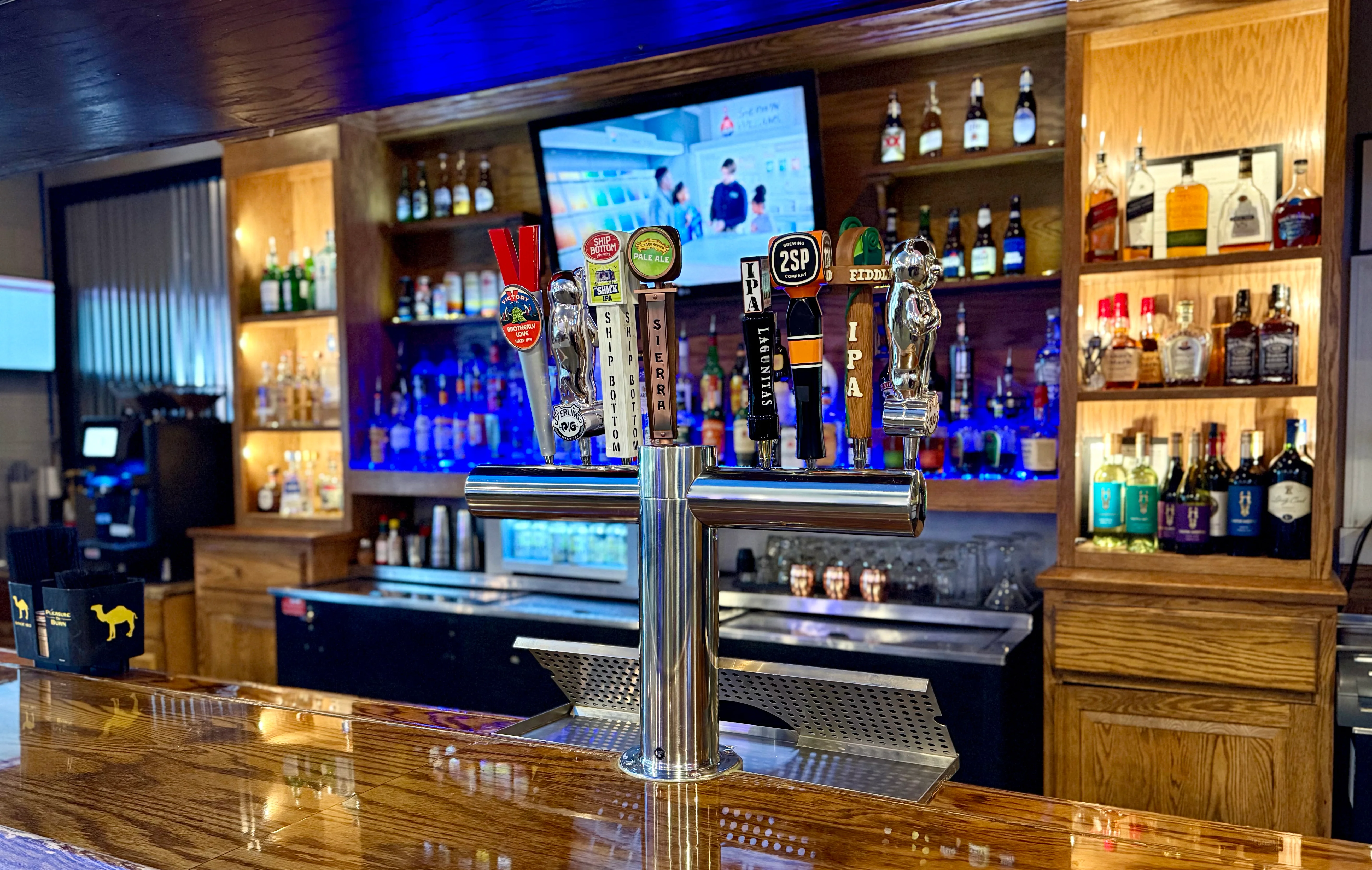 Modern bar counter with beer taps and liquor display