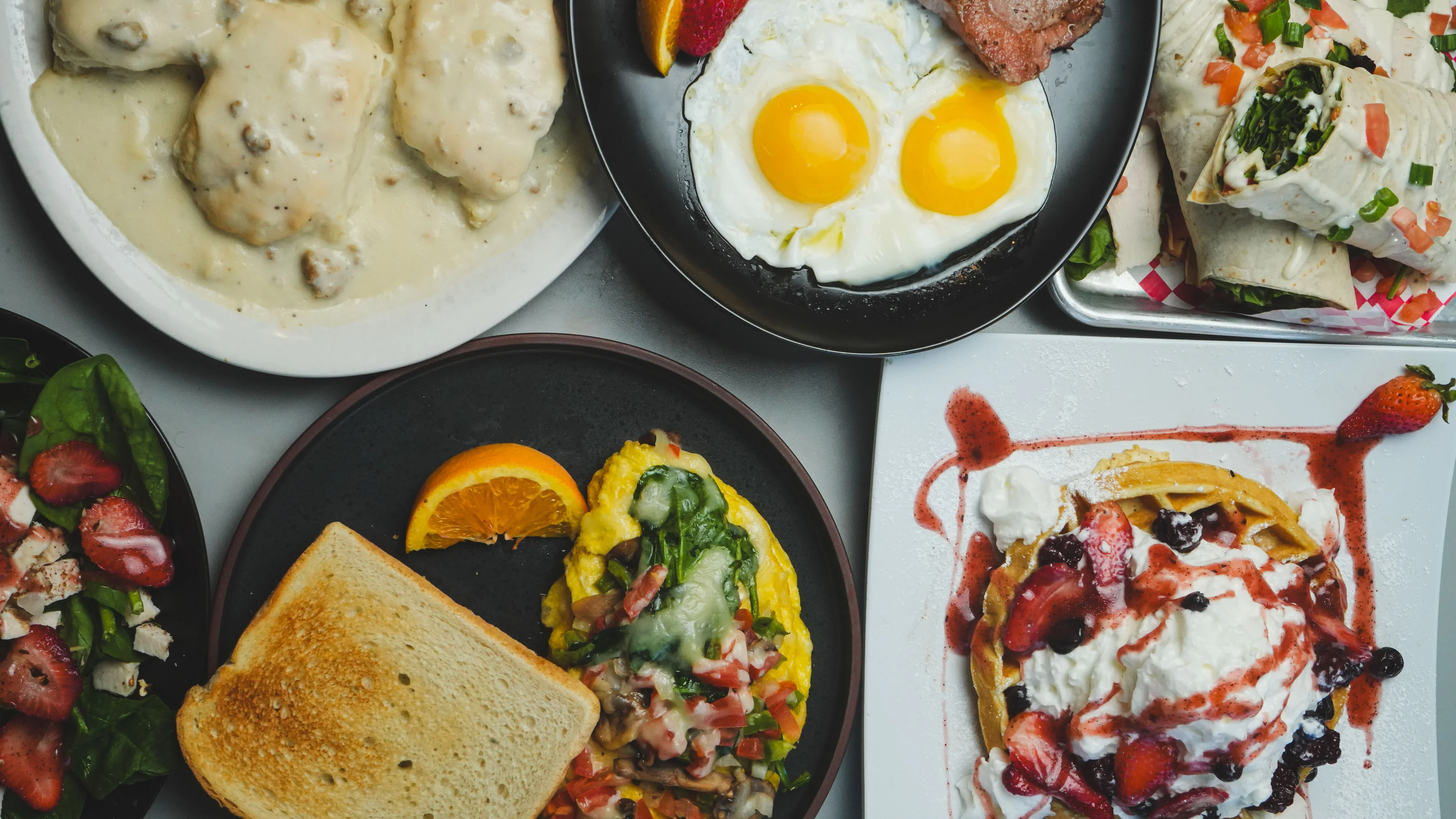 Hearty American breakfast spread with eggs, biscuits, and waffles