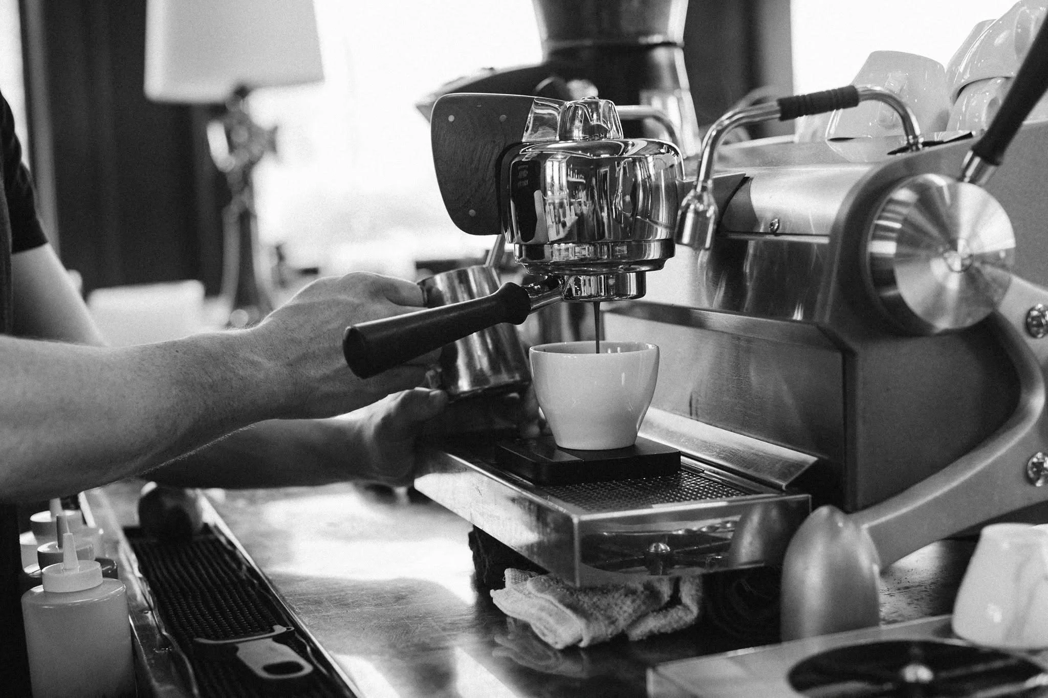 Barista preparing espresso shot in a coffee shop