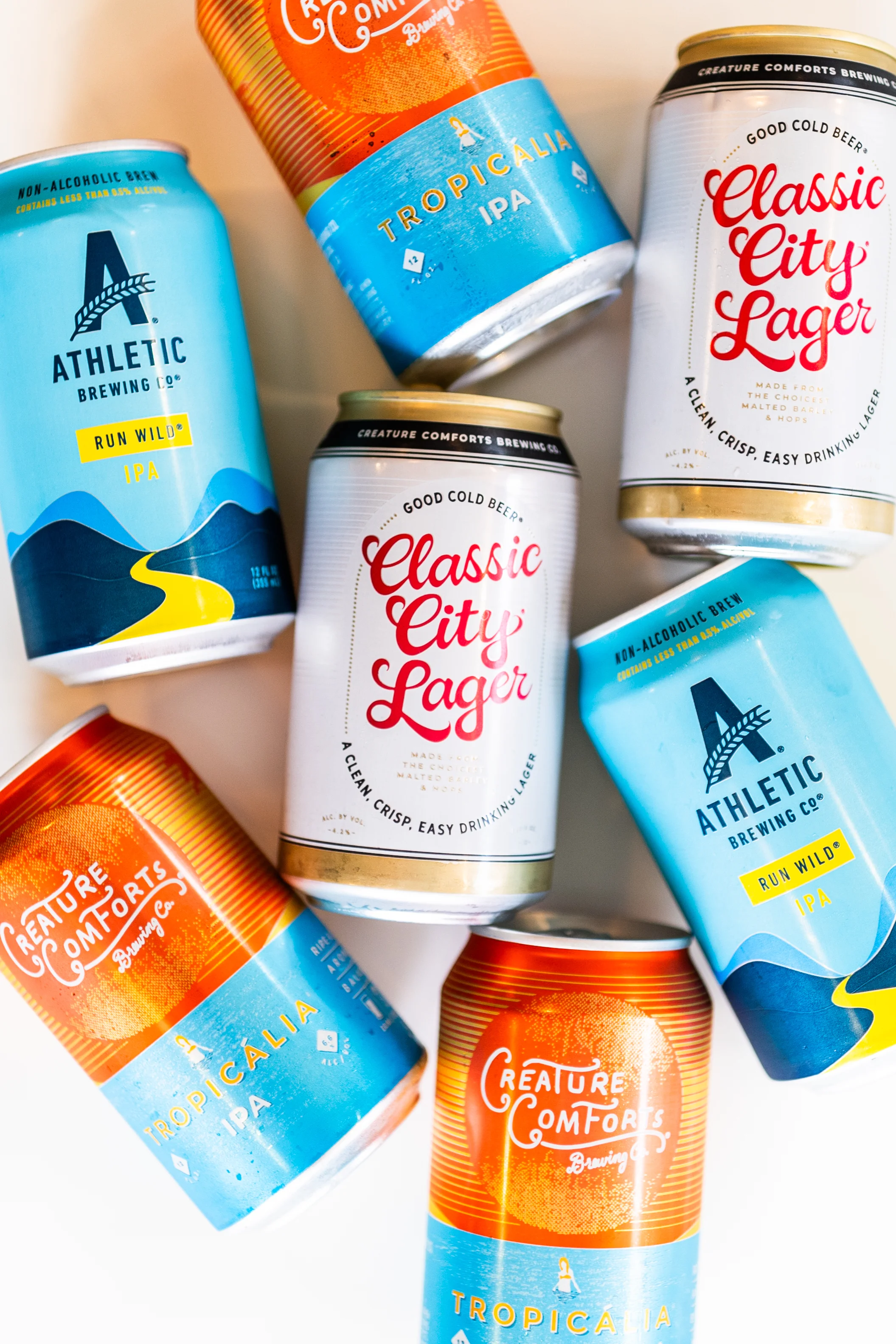Variety of craft beer cans from Athletic and Creature Comforts Brewing