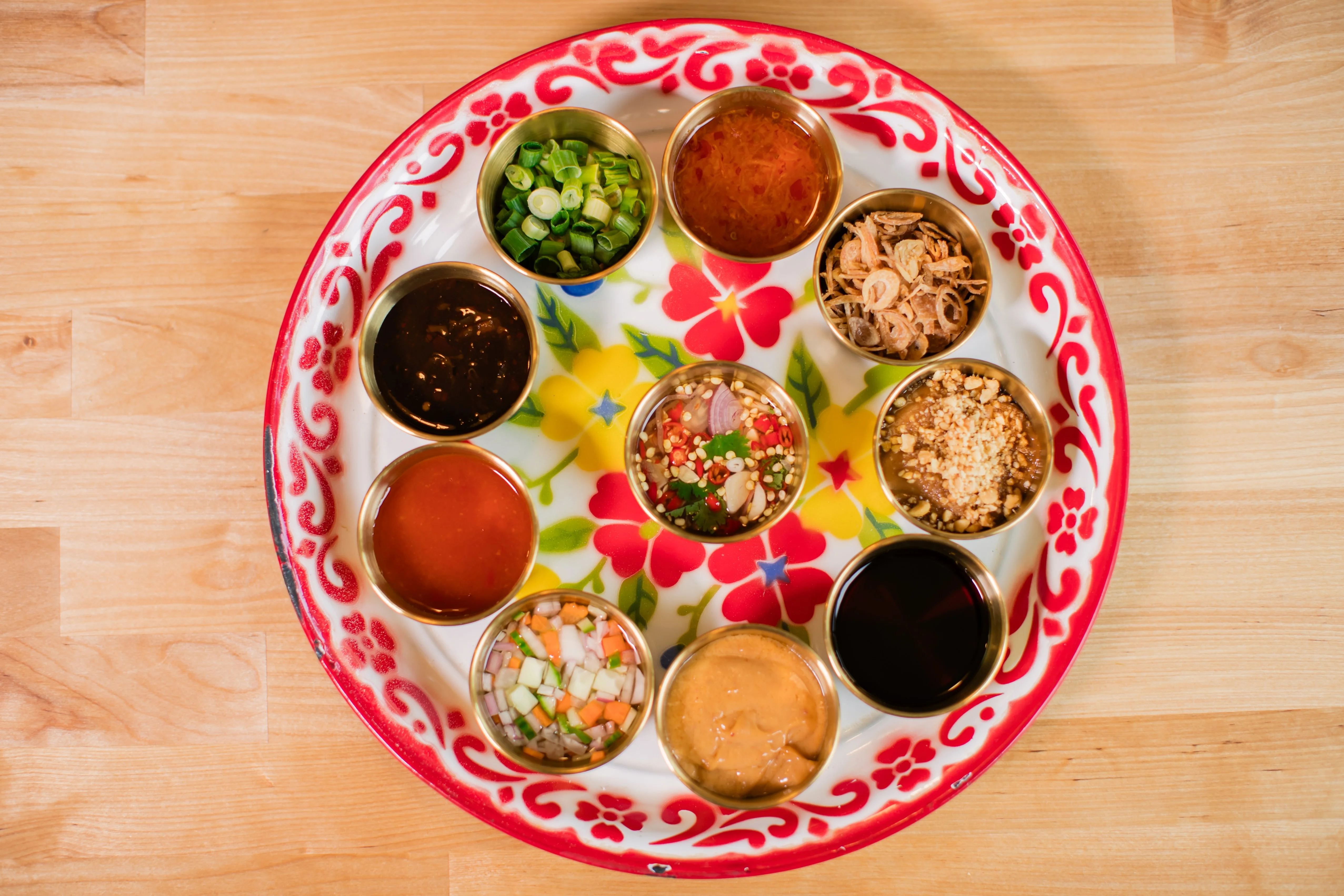 Thai dipping sauces platter with fresh herbs