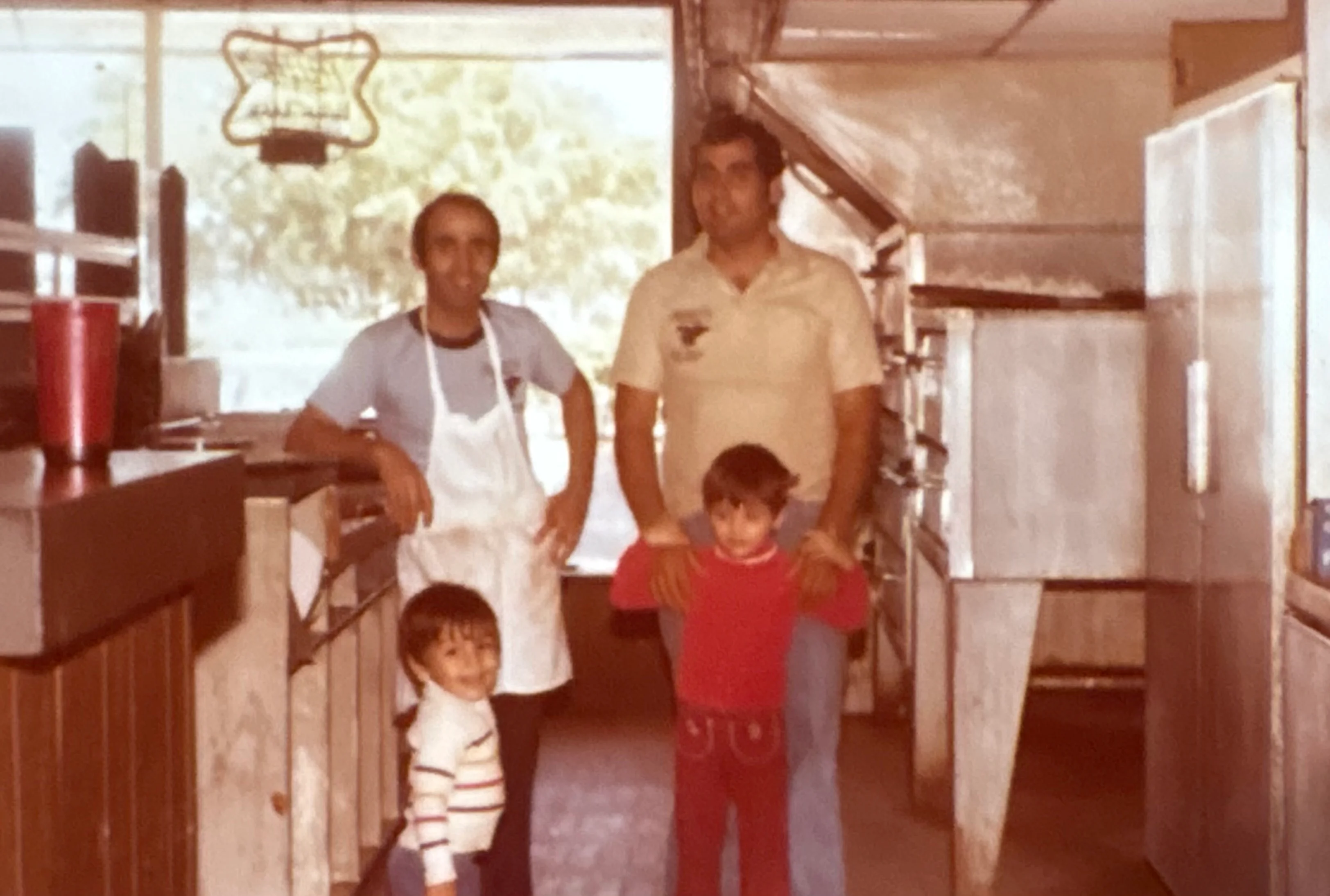 Family-owned restaurant interior with staff and children