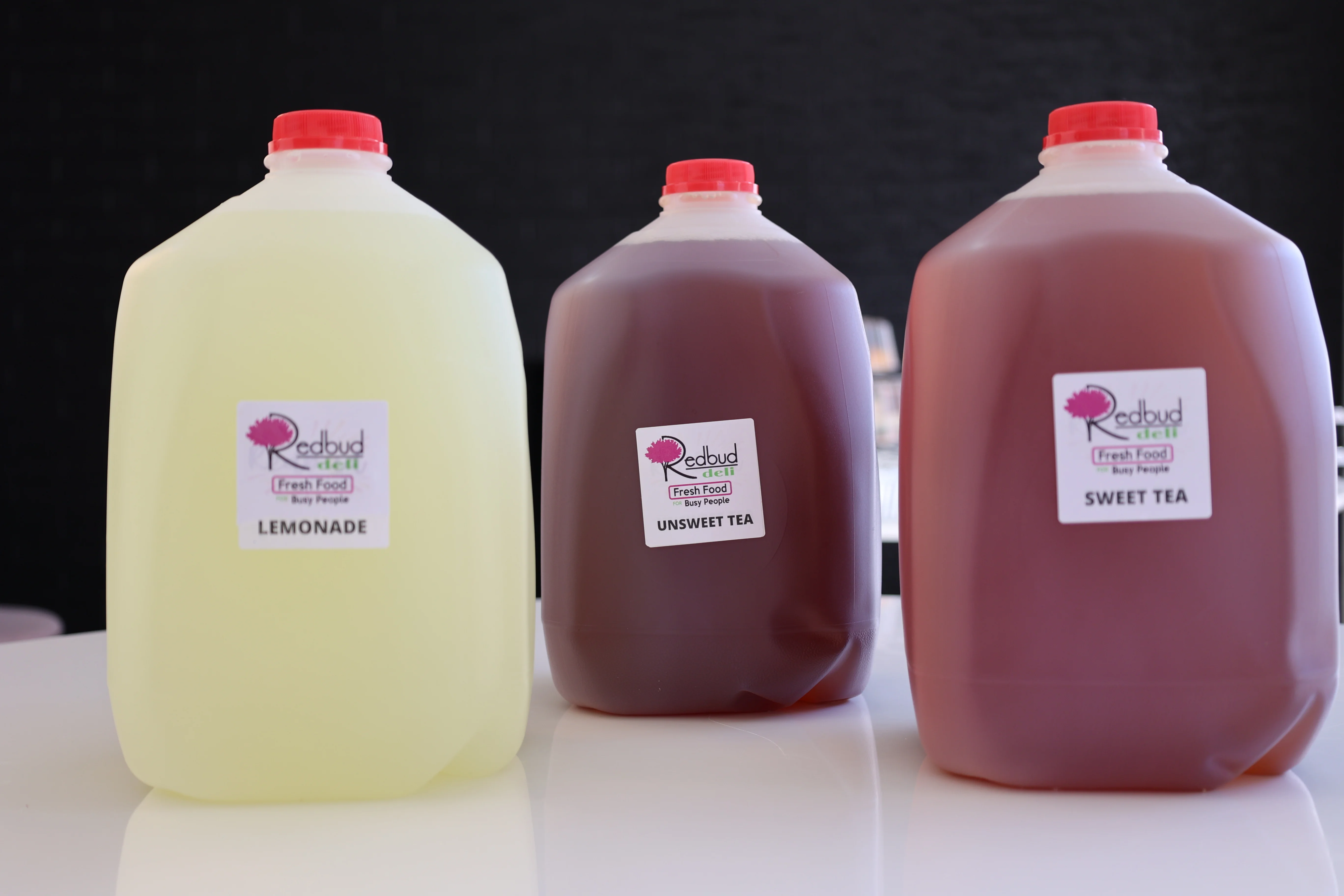 Refreshing beverages: lemonade, sweet tea, and unsweet tea in jugs