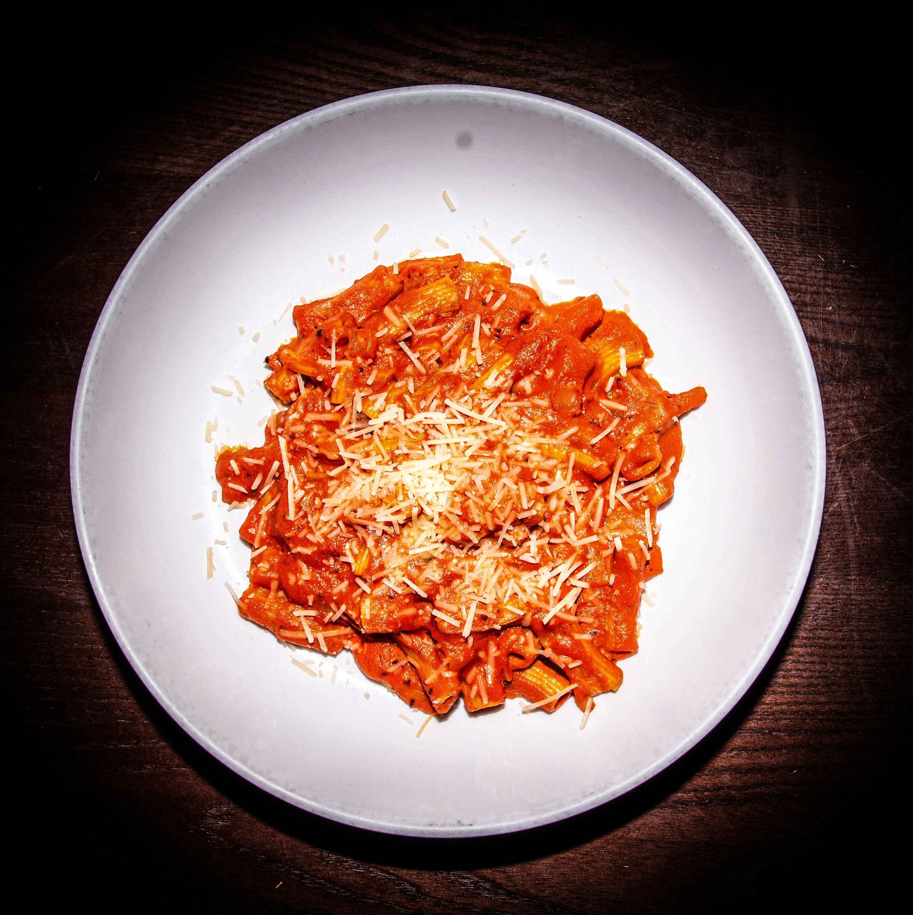 Creamy penne arrabbiata topped with parmesan