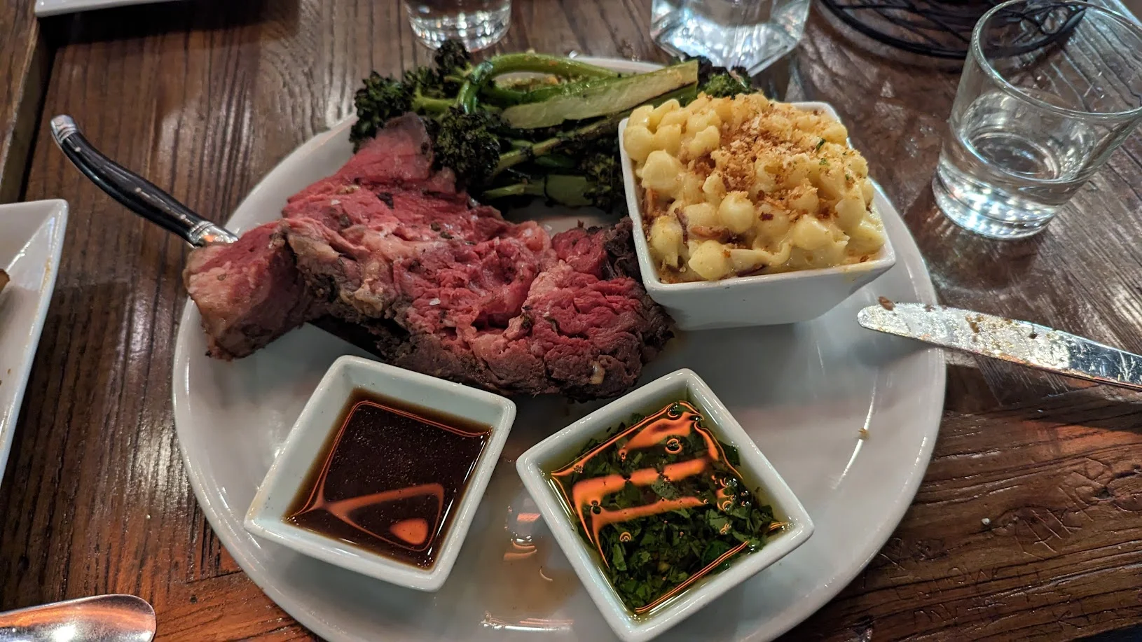 Juicy prime rib with sides of mac and cheese and broccolini