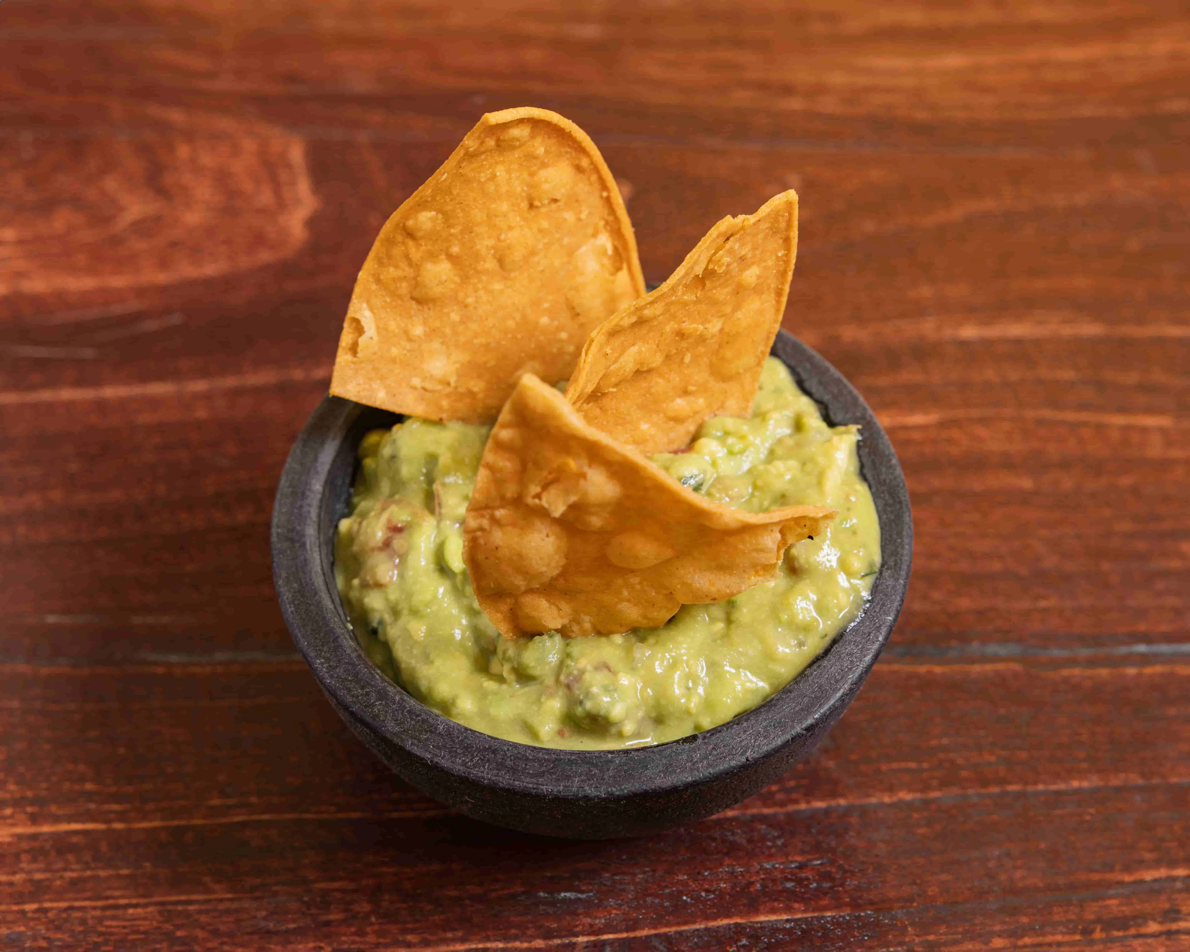 Bowl of guacamole with tortilla chips