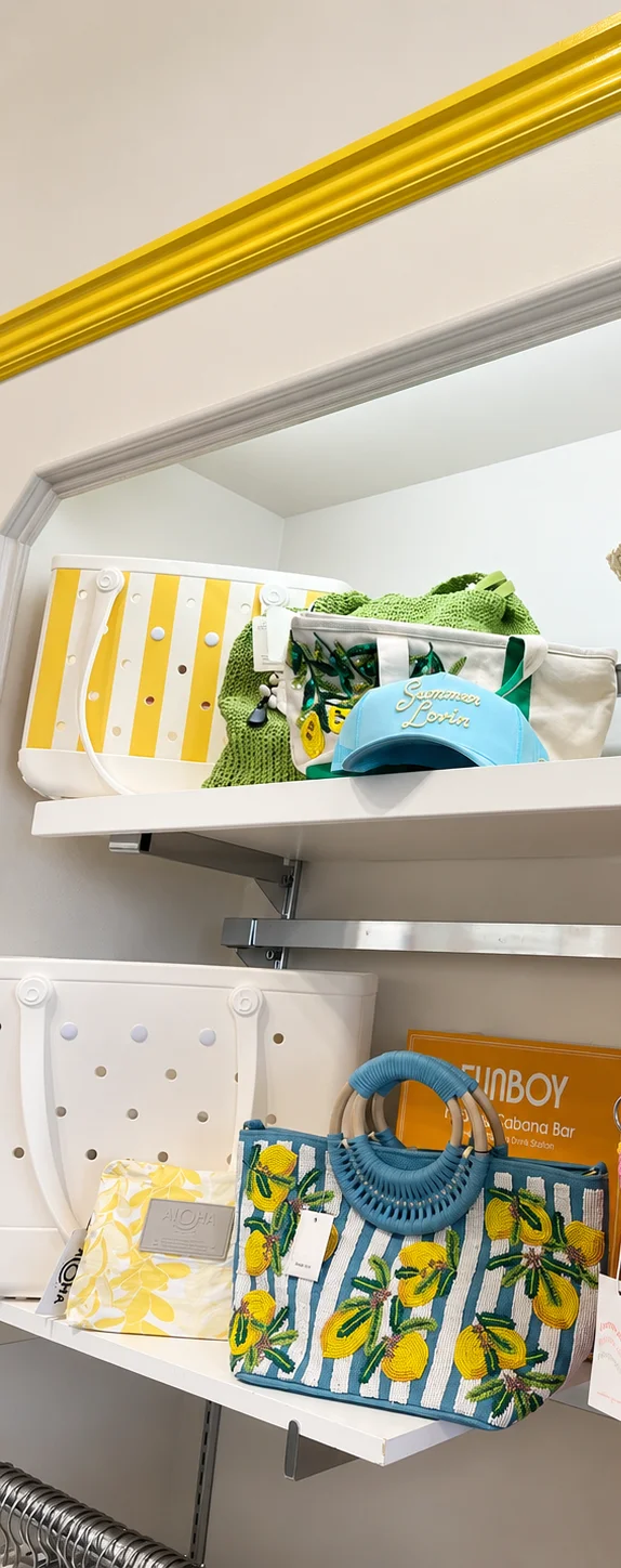 Colorful summer bags and accessories displayed on a retail shelf