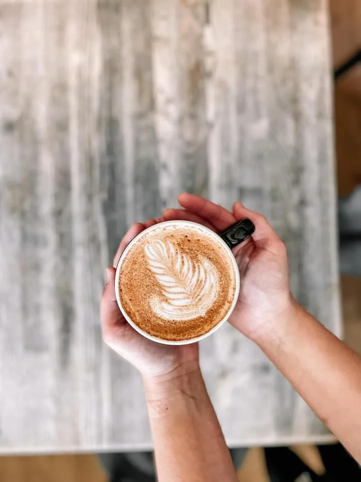 Artisan latte with beautiful foam art in a cozy café setting