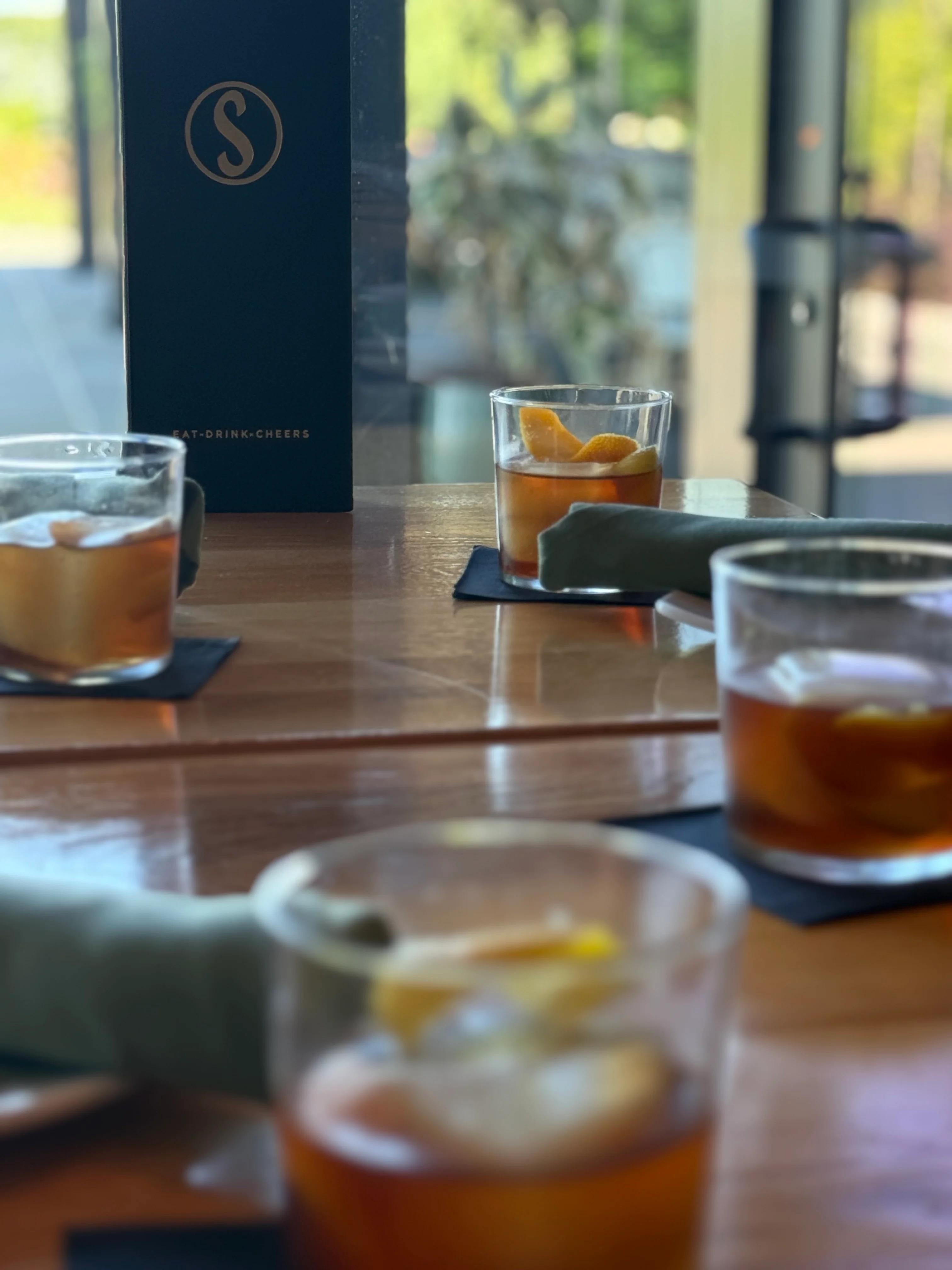 Cocktails served at a modern bar with a sleek menu