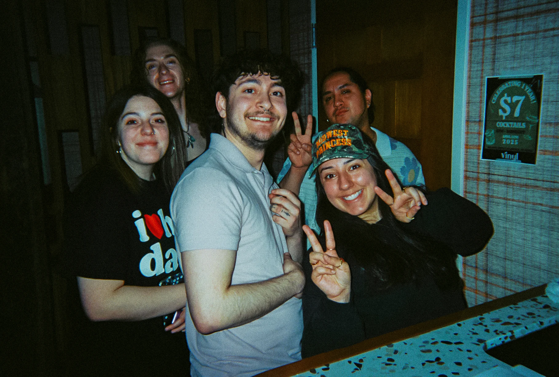 Group of friends posing happily at a bar