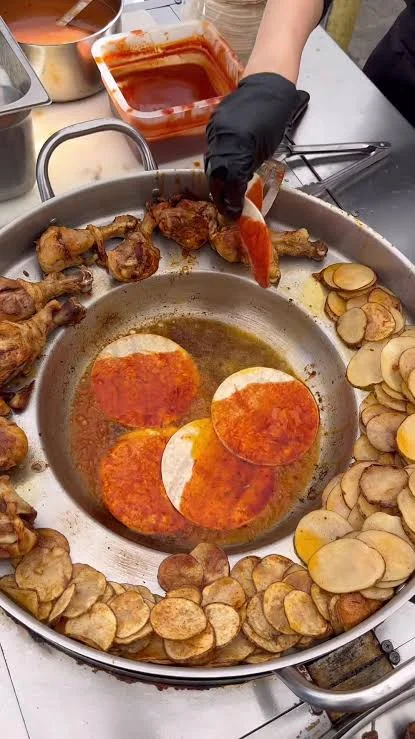 Sizzling Mexican tacos cooking with chicken and potatoes